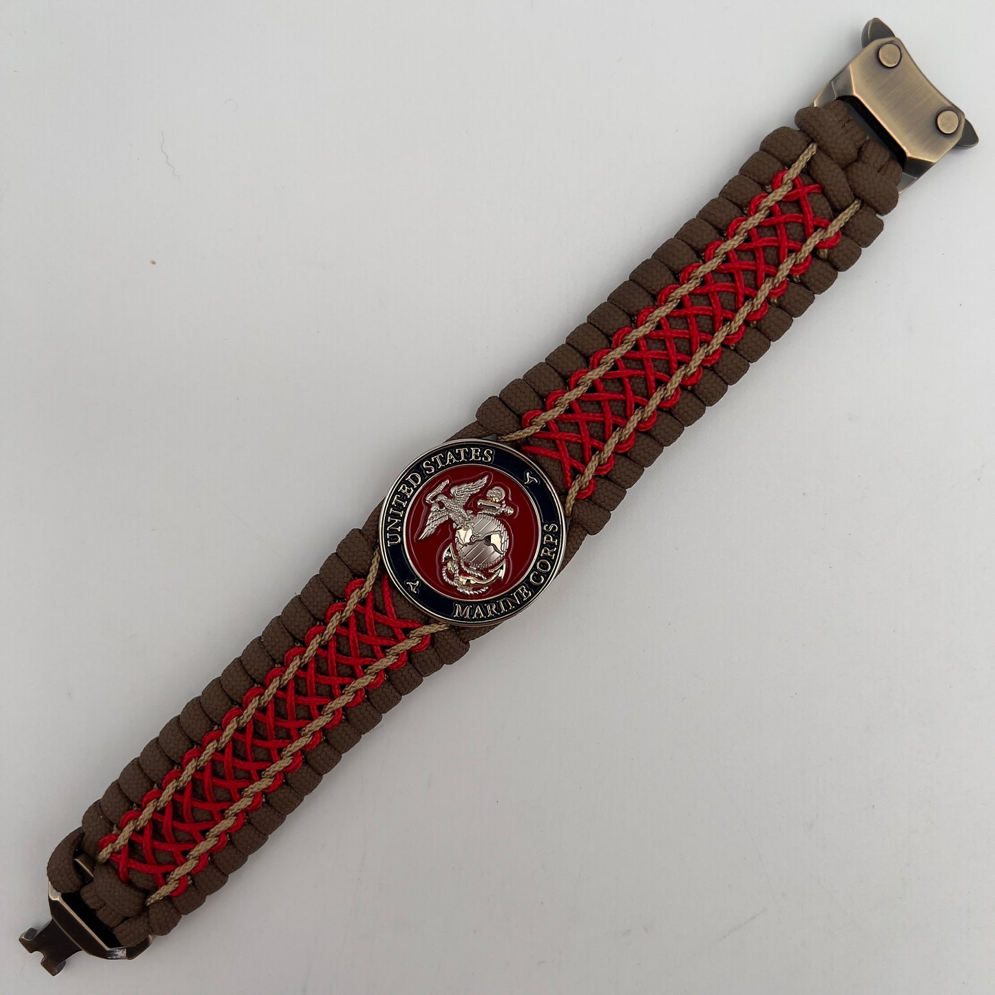 Thick and comfortable braided United States Marine Corps bracelet featuring a 24K gold and silver plated USMC officer Eagle Globe and Anchor medallion, a Cobra style tactical buckle and woven with Coyote Brown 550 paracord and Imperial Red and gold micro cord.