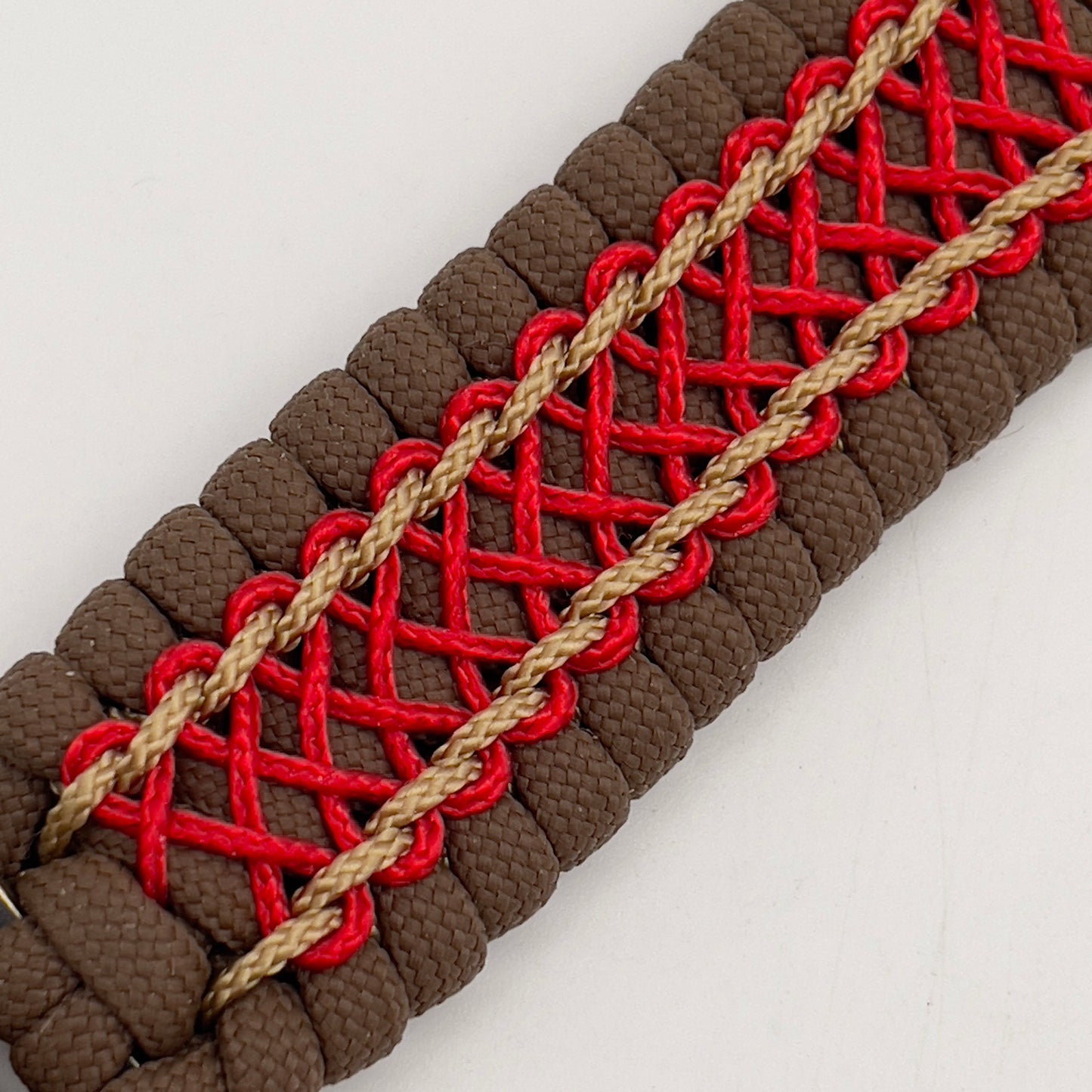 Thick and comfortable braided United States Marine Corps bracelet featuring a 24K gold and silver plated USMC officer Eagle Globe and Anchor medallion, a Cobra style tactical buckle and woven with Coyote Brown 550 paracord and Imperial Red and gold micro cord.