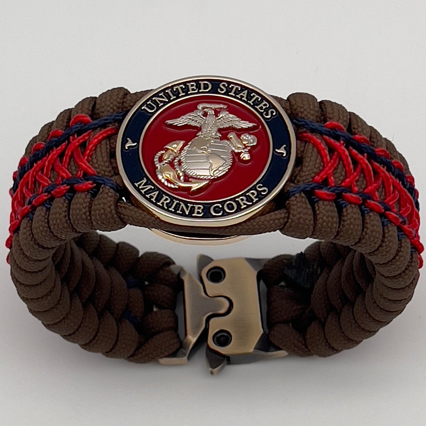 Thick and comfortable braided United States Marine Corps bracelet featuring a 24K gold and silver plated USMC officer Eagle Globe and Anchor medallion, a Cobra style tactical buckle and woven with Coyote Brown 550 paracord and Imperial Red and Navy Blue micro cord.