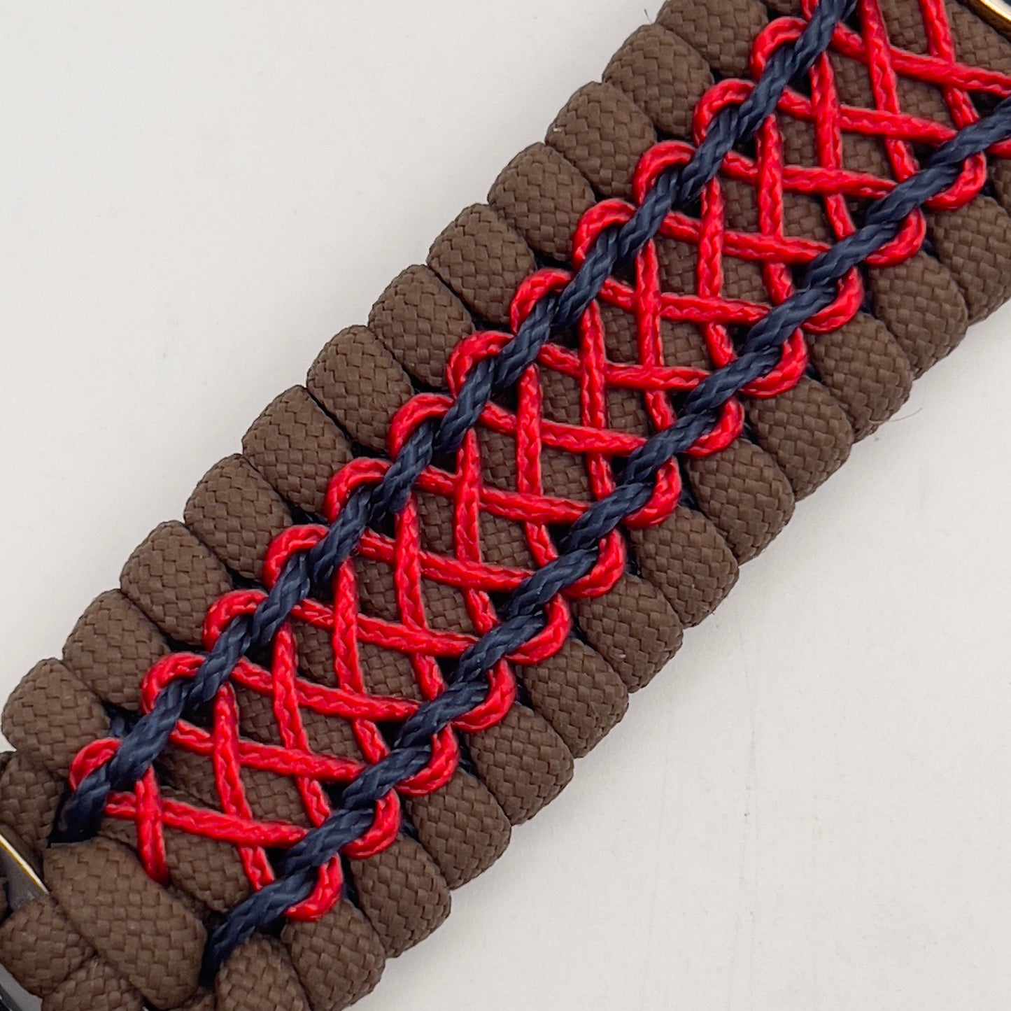 Thick and comfortable braided United States Marine Corps bracelet featuring a 24K gold and silver plated USMC officer Eagle Globe and Anchor medallion, a Cobra style tactical buckle and woven with Coyote Brown 550 paracord and Imperial Red and Navy Blue micro cord.