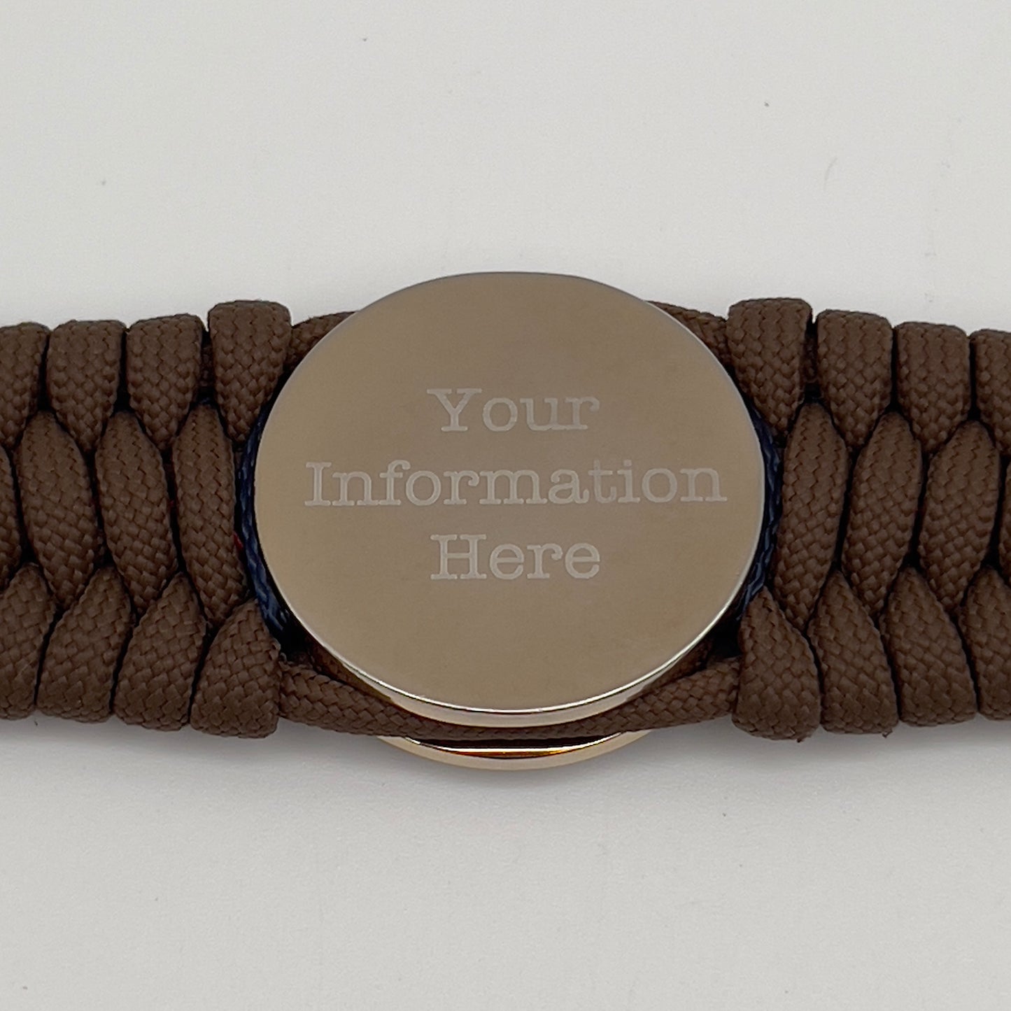 Thick and comfortable braided United States Marine Corps bracelet featuring a 24K gold and silver plated USMC officer Eagle Globe and Anchor medallion, a Cobra style tactical buckle and woven with Coyote Brown 550 paracord and Imperial Red and Navy Blue micro cord.