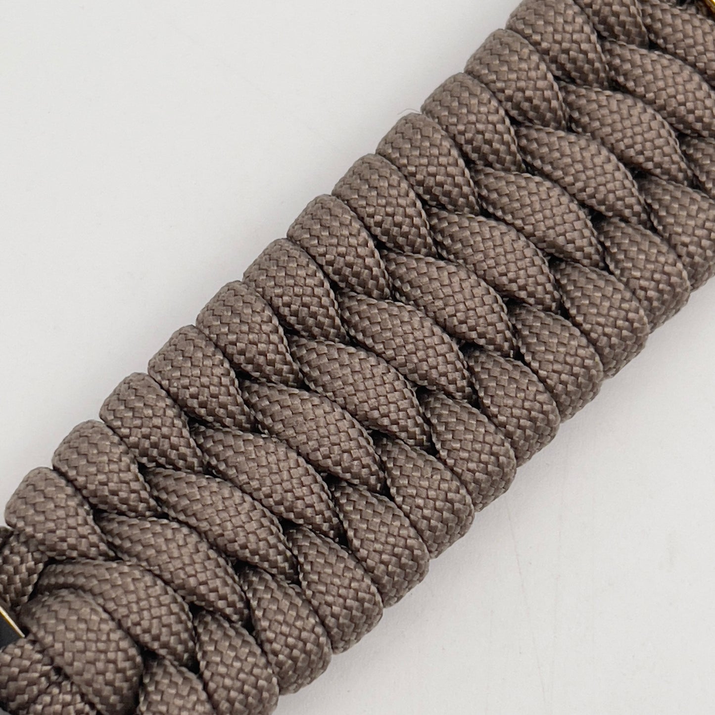 Thick and comfortable braided United States Marine Corps bracelet featuring a 24K gold and silver plated USMC officer Eagle Globe and Anchor medallion, a Cobra style tactical buckle and woven with tan 550 paracord.