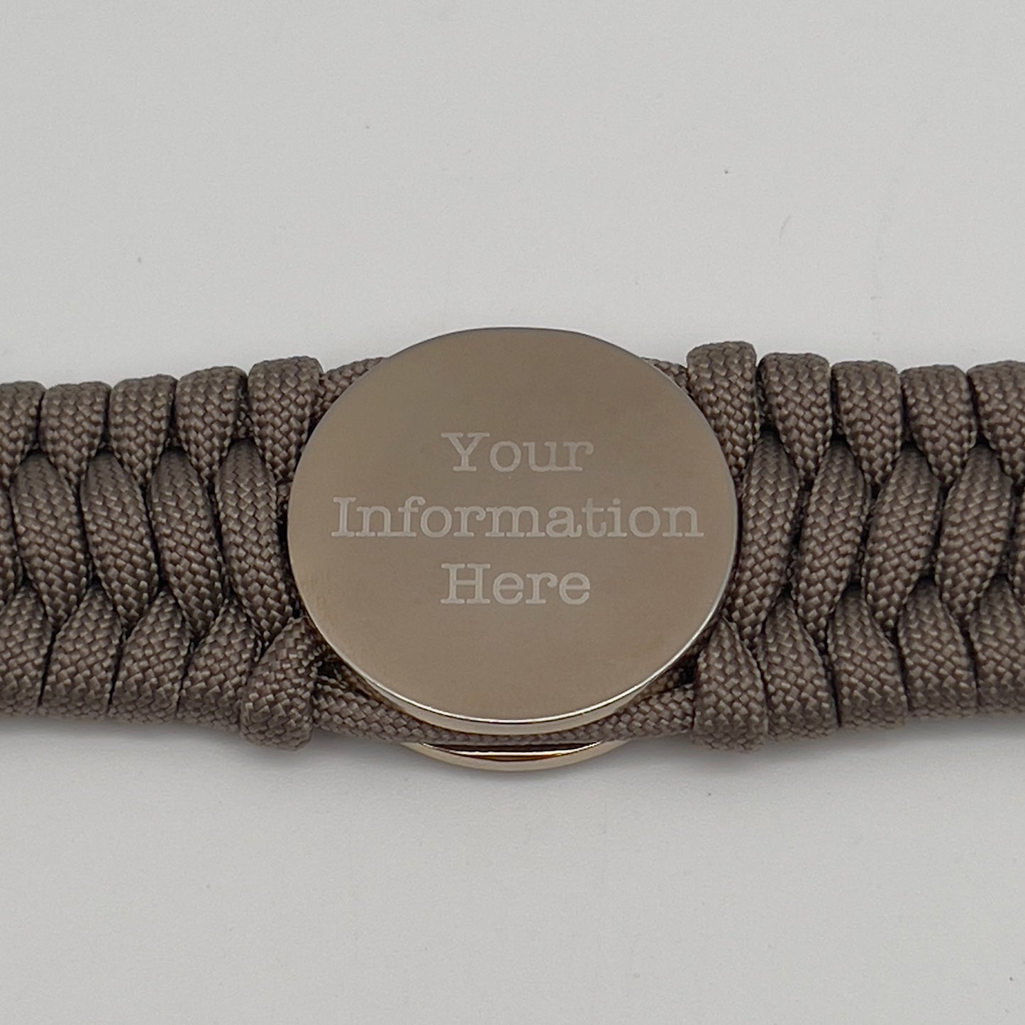 Thick and comfortable braided United States Marine Corps bracelet featuring a 24K gold and silver plated USMC officer Eagle Globe and Anchor medallion, a Cobra style tactical buckle and woven with tan 550 paracord.