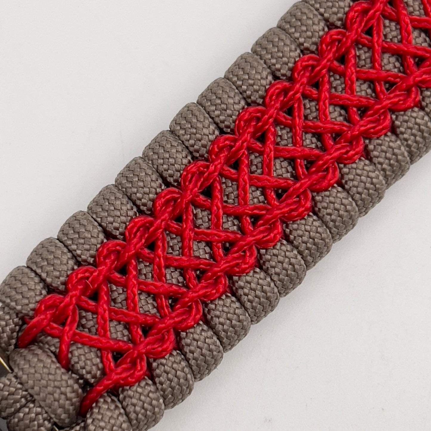 Thick, semi-rigid and comfortable braided United States Marine Corps bracelet featuring a 24K gold and silver plated USMC officer Eagle Globe and Anchor medallion, a gold Cobra style tactical buckle and woven with tan 550 paracord and Imperial red micro cord.