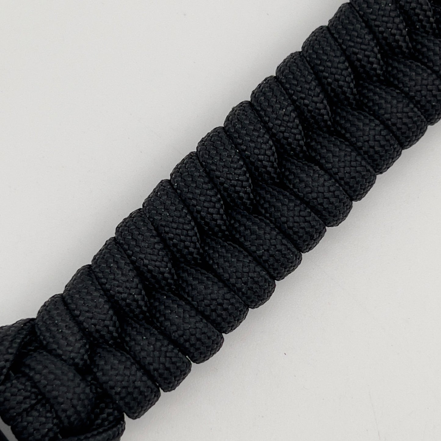Thick, semi-rigid and comfortable braided United States Marine Corps bracelet featuring a 24K gold plated USMC officer Eagle Globe and Anchor medallion, a black Cobra style tactical buckle and woven with black 550 paracord.