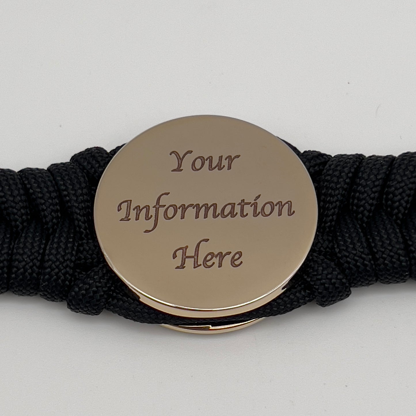 Thick, semi-rigid and comfortable braided United States Marine Corps bracelet featuring a 24K gold plated USMC officer Eagle Globe and Anchor medallion, a black Cobra style tactical buckle and woven with black 550 paracord.