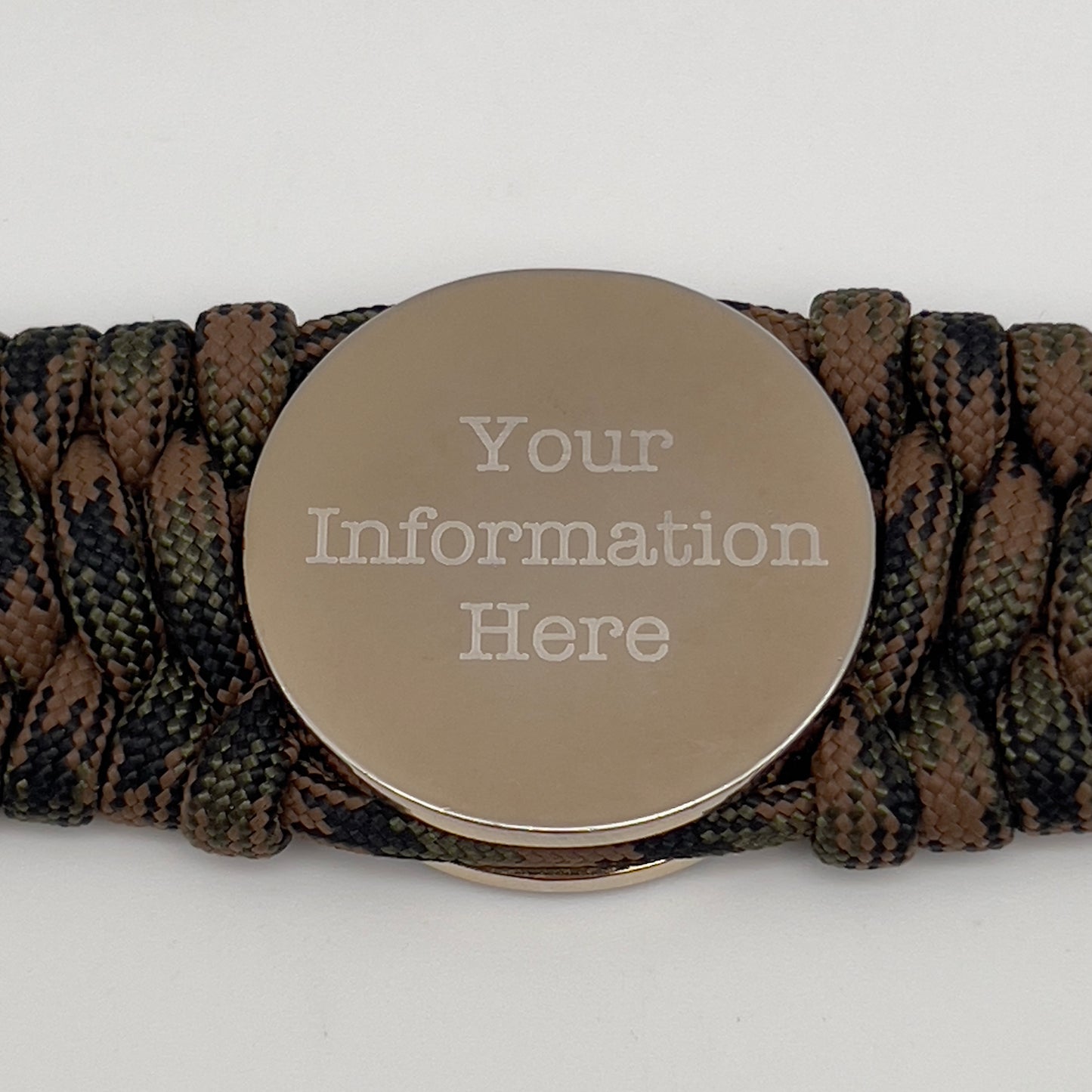 Thick, rigid and comfortable braided United States Marine Corps bracelet featuring a 24K gold and silver plated USMC officer Eagle Globe and Anchor medallion, a gold Cobra style tactical buckle and woven with Woodland Camo 550 paracord.