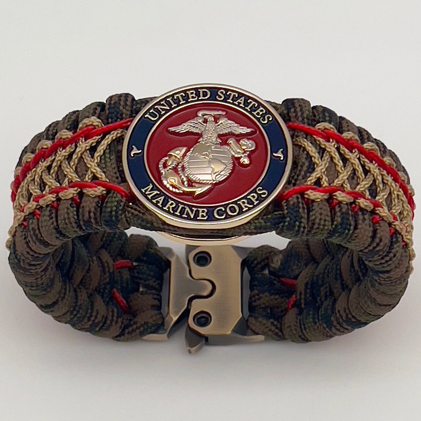 Thick, rigid and comfortable braided United States Marine Corps bracelet featuring a 24K gold and silver plated USMC officer Eagle Globe and Anchor medallion, a gold Cobra style tactical buckle and woven with Woodland Camo 550 paracord and Imperial Red and gold micro cord.