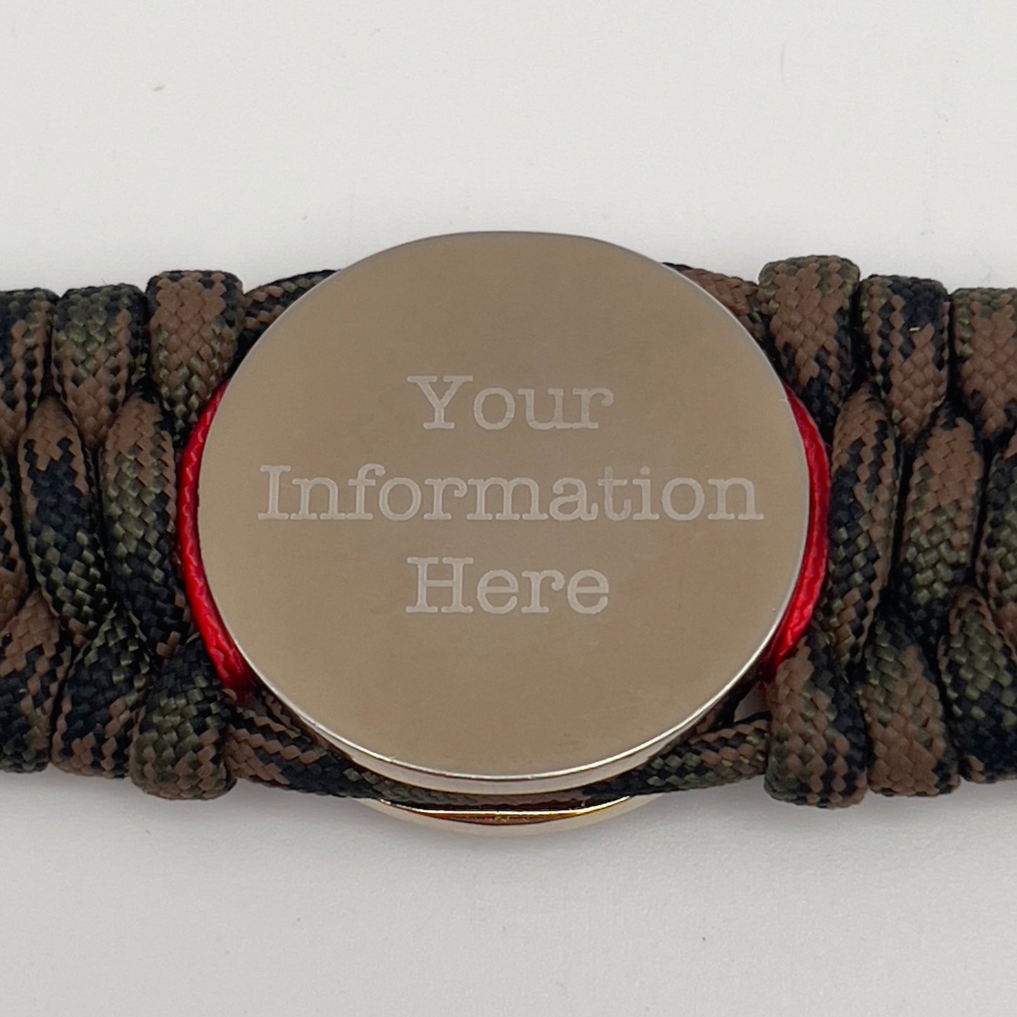 Thick, rigid and comfortable braided United States Marine Corps bracelet featuring a 24K gold and silver plated USMC officer Eagle Globe and Anchor medallion, a gold Cobra style tactical buckle and woven with Woodland Camo 550 paracord and Imperial Red and gold micro cord.