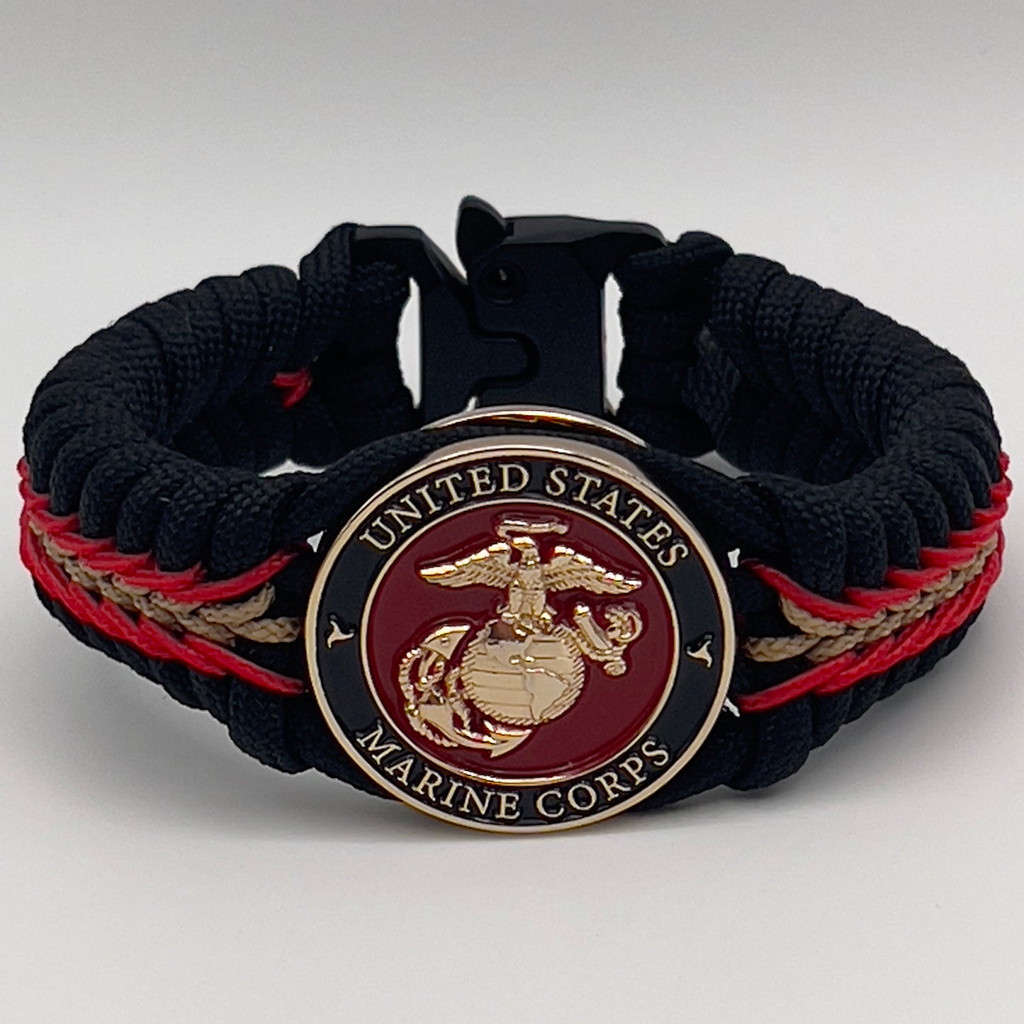 Thick, semi-rigid and comfortable braided United States Marine Corps bracelet featuring a 24K gold and silver plated USMC officer Eagle Globe and Anchor medallion, a black Cobra style tactical buckle and woven with black 550, Imperial red and gold micro paracord.