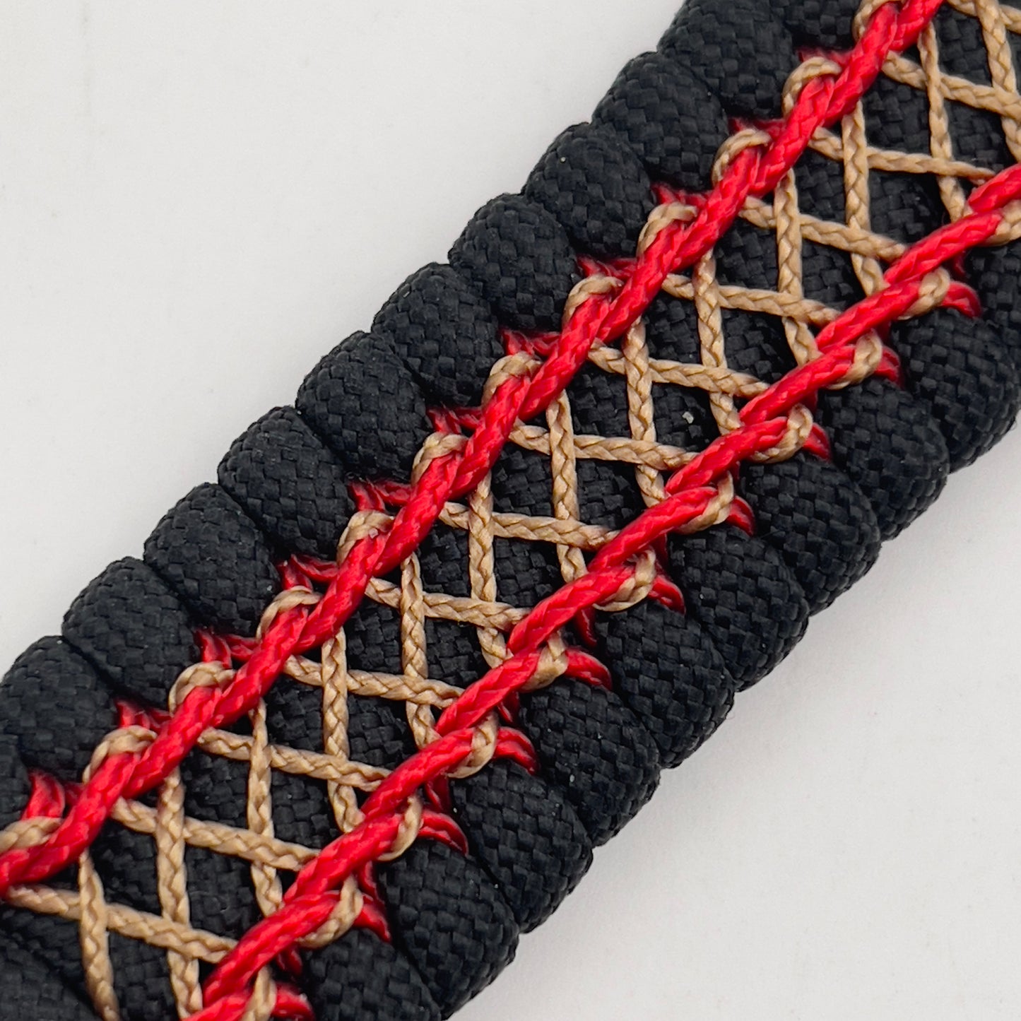 Thick, wide, rigid and comfortable braided United States Marine Corps bracelet featuring a 24K gold plated USMC Eagle Globe and Anchor medallion, a black Cobra style tactical buckle and woven with black 550 paracord and Imperial Red micro and gold nano cord.