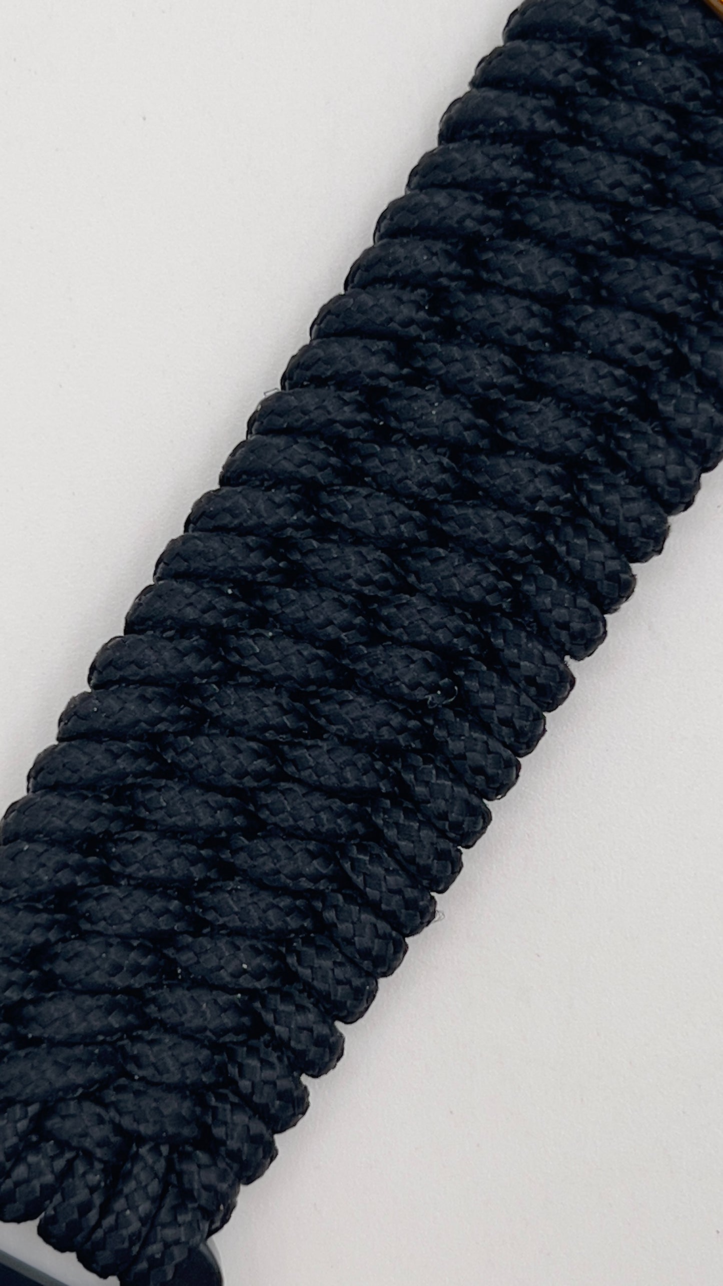 Thin, wide, very flexible and comfortable braided United States Marine Corps bracelet featuring a 24K antique gold plated USMC Eagle Globe and Anchor medallion engraved with the Punisher logo, a black Cobra style tactical buckle and woven with black Type-1 paracord.