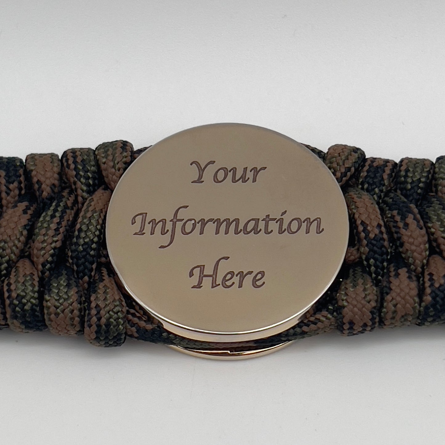 Thick, wide, semi-rigid and comfortable braided United States Marine Corps bracelet featuring a 24K gold plated USMC Eagle Globe and Anchor medallion, a gold Cobra style tactical buckle and woven with Woodland Camo 550 paracord.