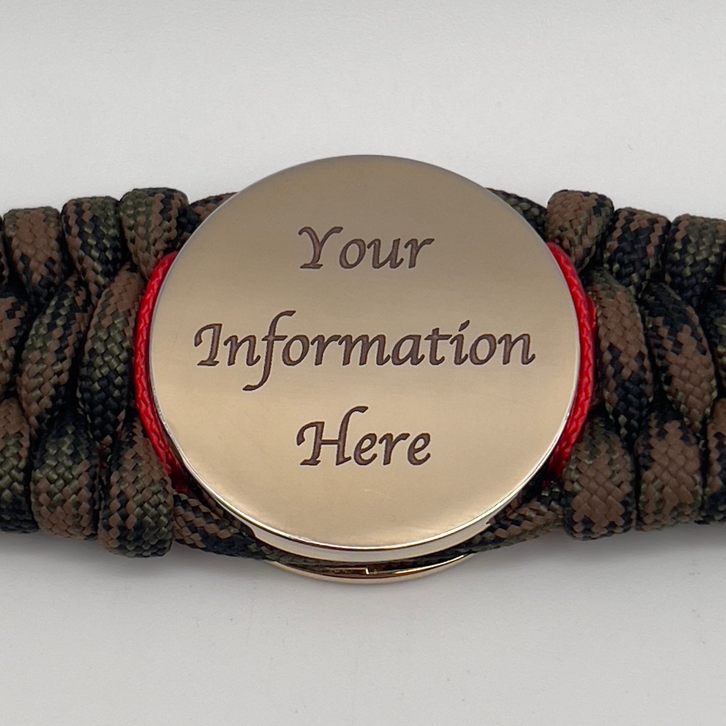 Thick, wide, rigid and comfortable braided United States Marine Corps bracelet featuring a 24K gold plated USMC Eagle Globe and Anchor medallion, a gold Cobra style tactical buckle and woven with Woodland Camo 550 paracord and Imperial Red nano and micro cord.