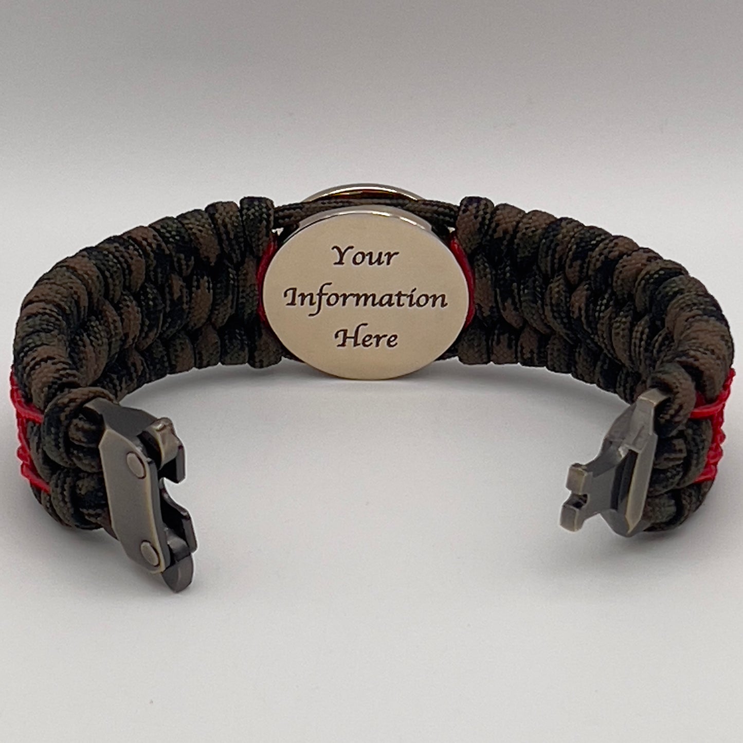 Thick, wide, rigid and comfortable braided United States Marine Corps bracelet featuring a 24K gold plated USMC Eagle Globe and Anchor medallion, a gold Cobra style tactical buckle and woven with Woodland Camo 550 paracord and Imperial Red nano and micro cord.