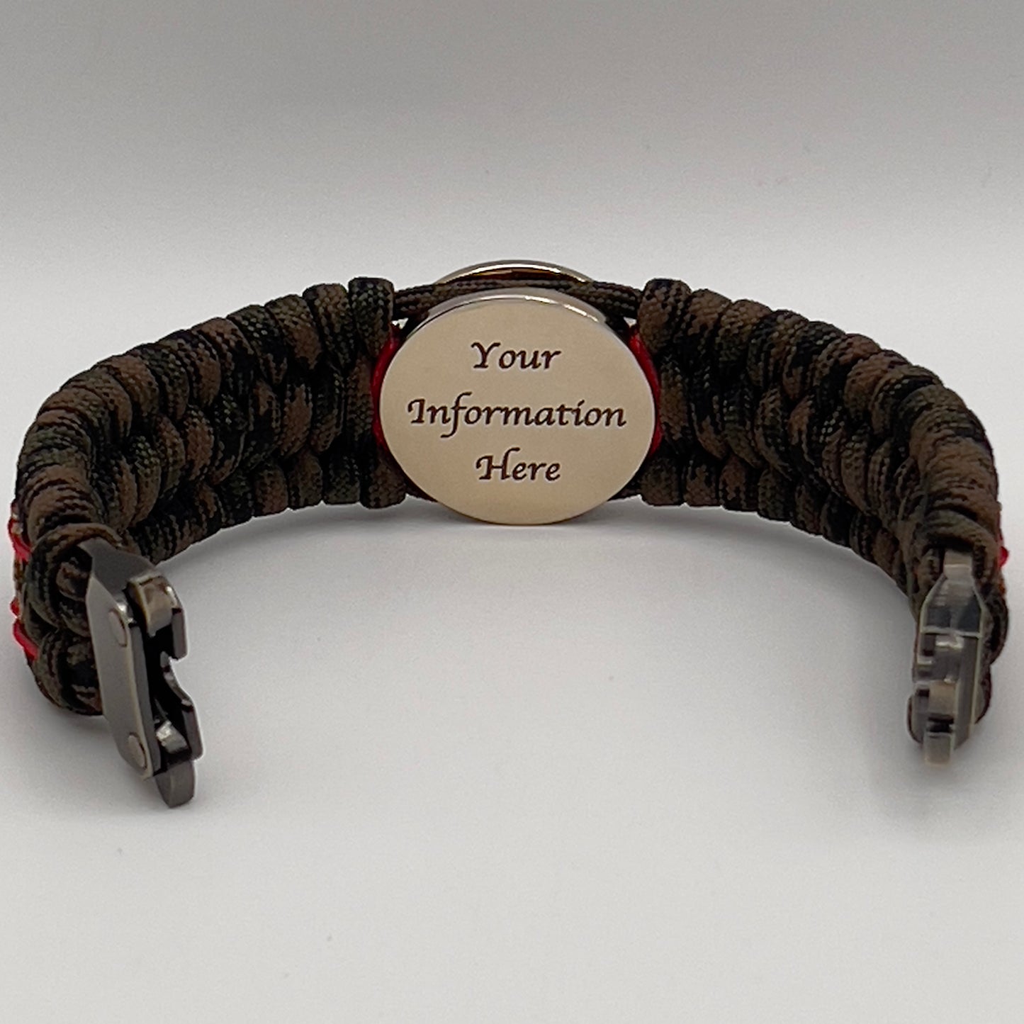 Thick, wide, rigid and comfortable braided United States Marine Corps bracelet featuring a 24K gold plated USMC Eagle Globe and Anchor medallion, a gold Cobra style tactical buckle and woven with Woodland Camo 550 paracord and Imperial Red micro and gold nano cord.