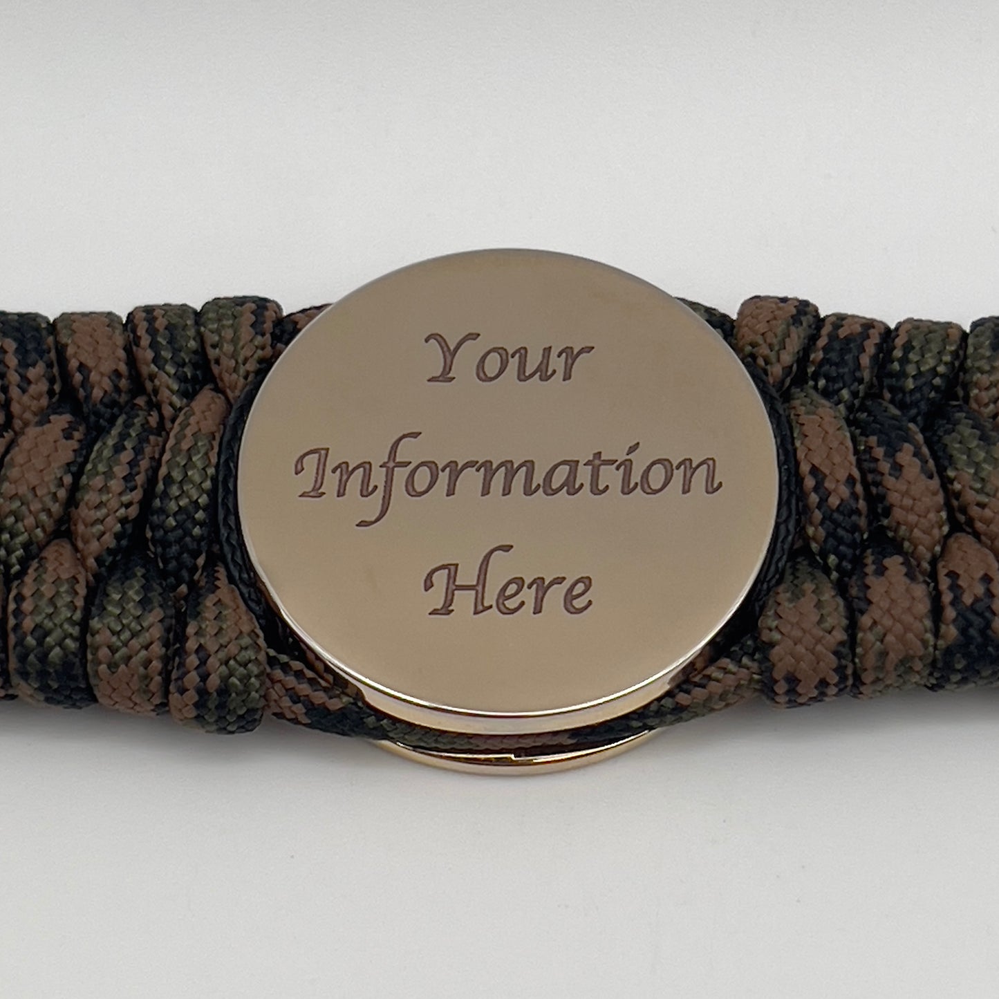 Thick, wide, rigid and comfortable braided United States Marine Corps bracelet featuring a 24K gold plated USMC Eagle Globe and Anchor medallion, a gold Cobra style tactical buckle and woven with Woodland Camo 550 paracord and Imperial Red micro and black nano cord.