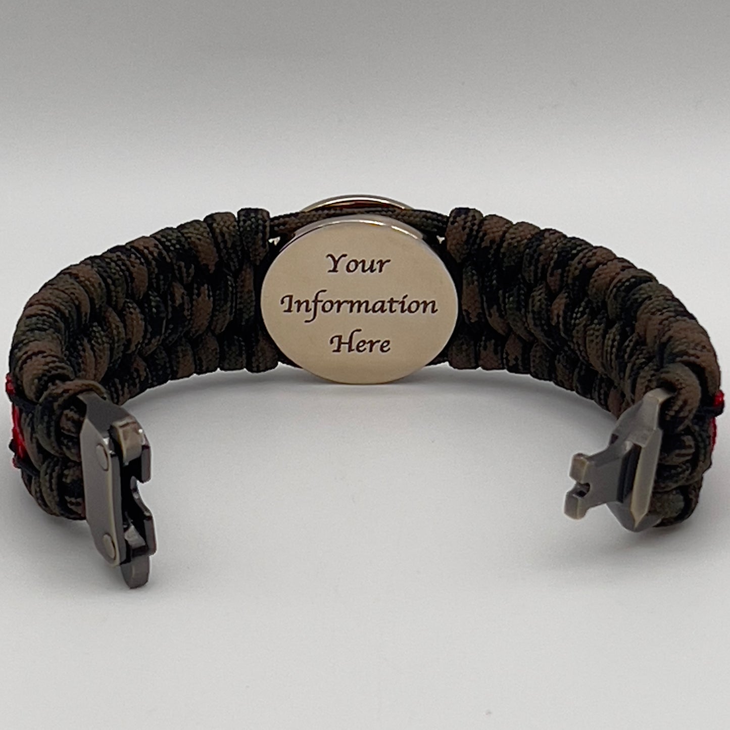 Thick, wide, rigid and comfortable braided United States Marine Corps bracelet featuring a 24K gold plated USMC Eagle Globe and Anchor medallion, a gold Cobra style tactical buckle and woven with Woodland Camo 550 paracord and Imperial Red micro and black nano cord.