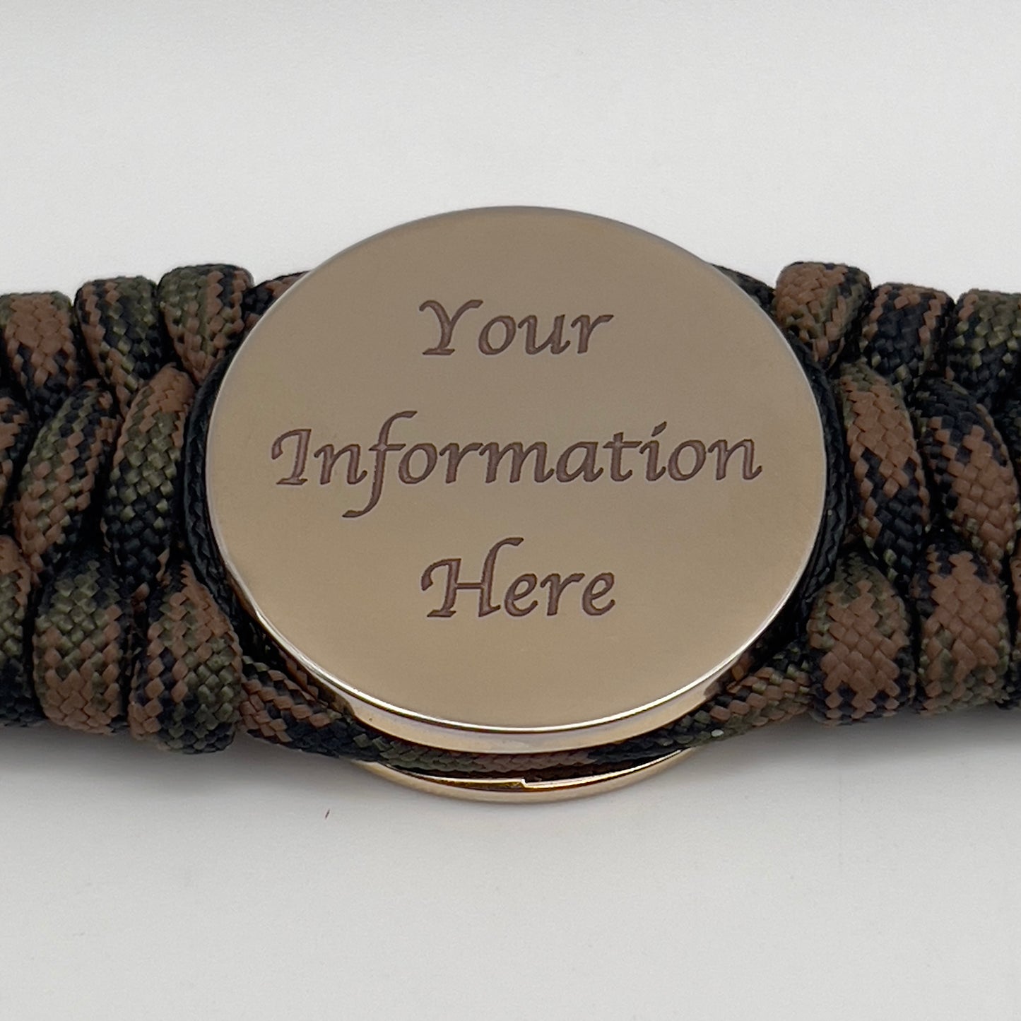 Thick, wide, rigid and comfortable braided United States Marine Corps bracelet featuring a 24K gold plated USMC Eagle Globe and Anchor medallion, a gold Cobra style tactical buckle and woven with Woodland 550 paracord, black micro and tan nano cord.