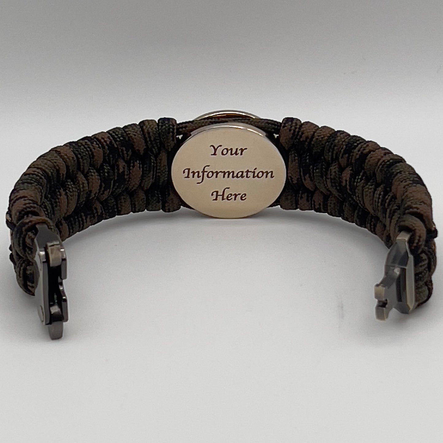 Thick, wide, rigid and comfortable braided United States Marine Corps bracelet featuring a 24K gold plated USMC Eagle Globe and Anchor medallion, a gold Cobra style tactical buckle and woven with Woodland 550 paracord, black micro and tan nano cord.