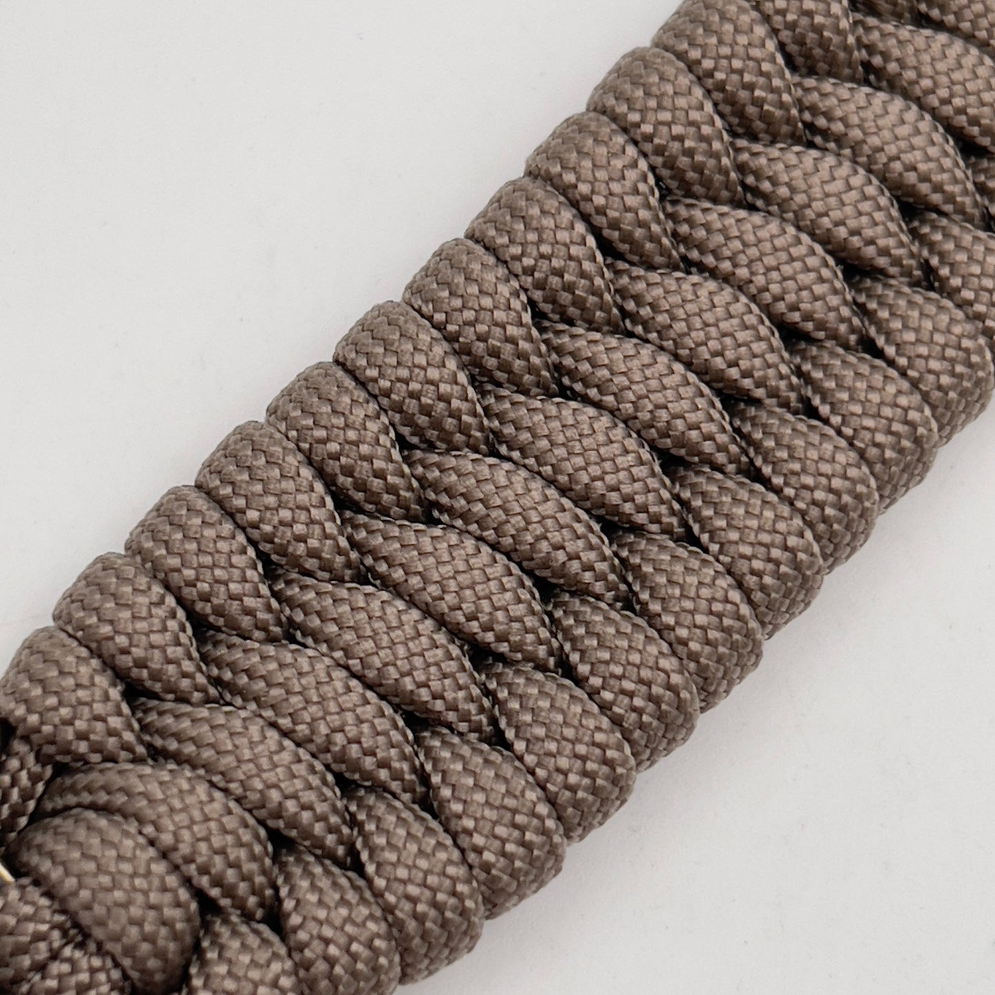 Thick, wide, semi-rigid and comfortable braided United States Marine Corps bracelet featuring a 24K gold plated USMC Eagle Globe and Anchor medallion, a gold Cobra style tactical buckle and woven with tan 550 paracord.