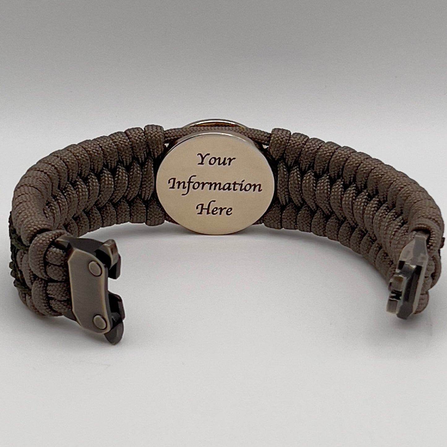 Thick, wide, rigid and comfortable braided United States Marine Corps bracelet featuring a 24K gold plated USMC Eagle Globe and Anchor medallion, a gold Cobra style tactical buckle and woven with tan 550 paracord and olive drab nano and micro cord.