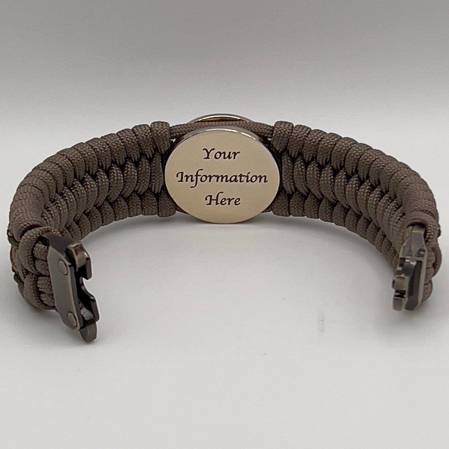 Thick, wide, rigid and comfortable braided United States Marine Corps bracelet featuring a 24K gold plated USMC Eagle Globe and Anchor medallion, a gold Cobra style tactical buckle and woven with tan 550 paracord and olive drab micro and tan nano cord.