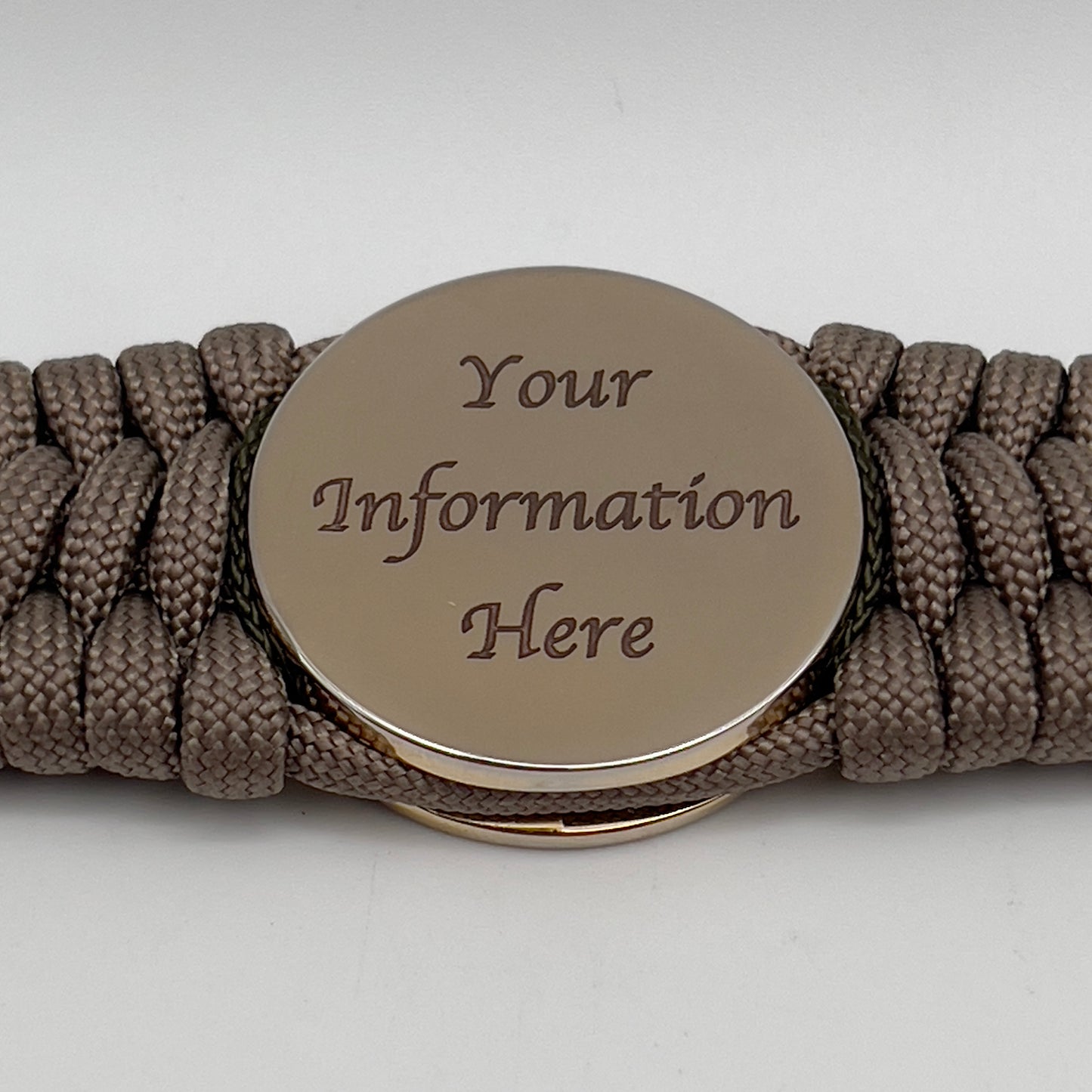 Thick, wide, rigid and comfortable braided United States Marine Corps bracelet featuring a 24K gold plated USMC Eagle Globe and Anchor medallion, a gold Cobra style tactical buckle and woven with tan 550 paracord, olive drab micro and Imperial red nano cord.