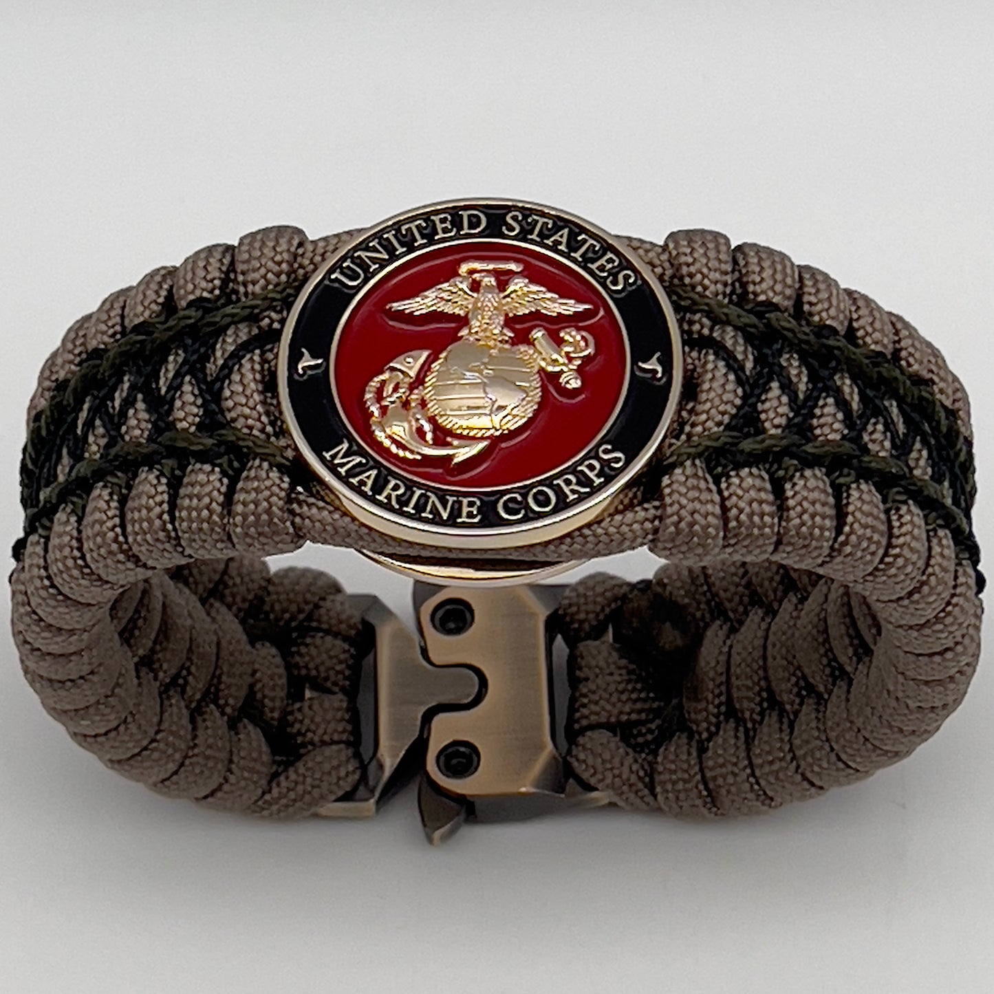 Thick, wide, rigid and comfortable braided United States Marine Corps bracelet featuring a 24K gold plated USMC Eagle Globe and Anchor medallion, a gold Cobra style tactical buckle and woven with tan 550 paracord, olive drab micro and black nano cord.