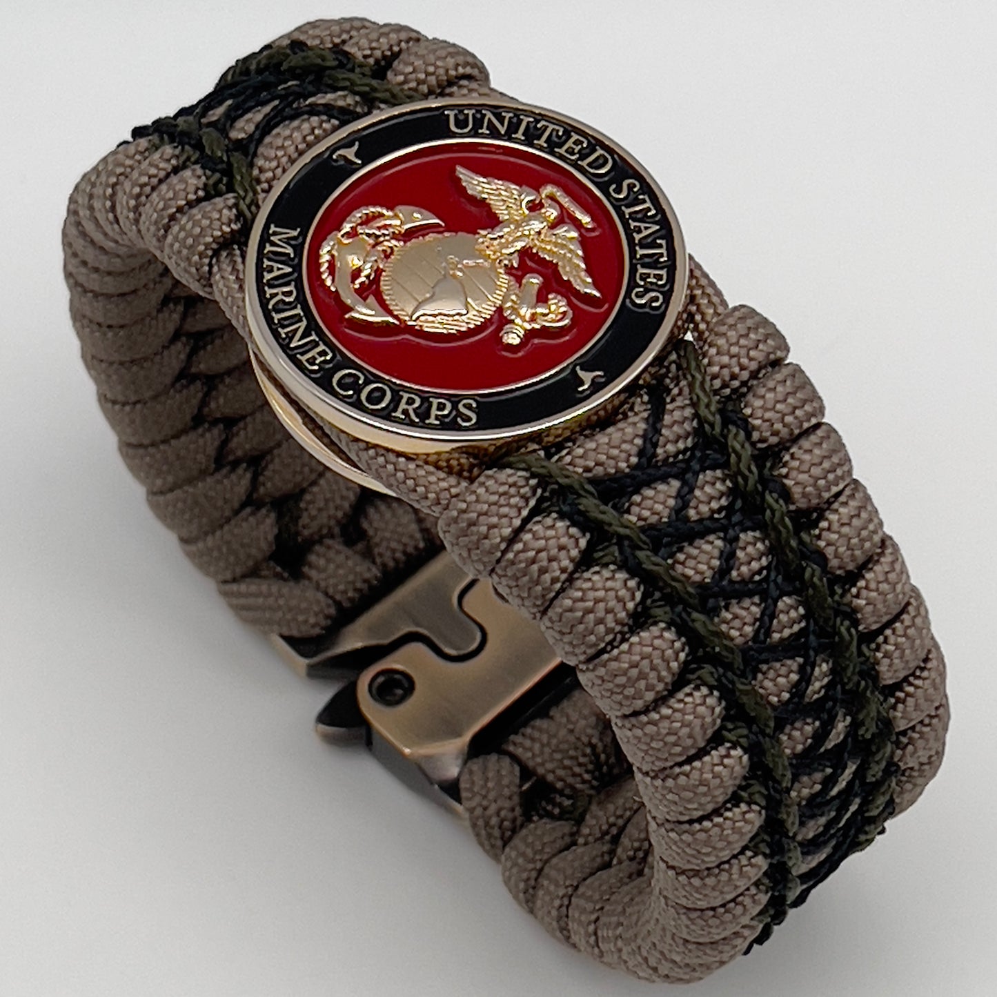 Thick, wide, rigid and comfortable braided United States Marine Corps bracelet featuring a 24K gold plated USMC Eagle Globe and Anchor medallion, a gold Cobra style tactical buckle and woven with tan 550 paracord, olive drab micro and black nano cord.