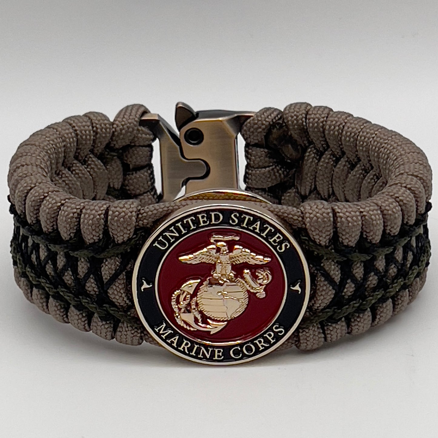 Thick, wide, rigid and comfortable braided United States Marine Corps bracelet featuring a 24K gold plated USMC Eagle Globe and Anchor medallion, a gold Cobra style tactical buckle and woven with tan 550 paracord, olive drab micro and black nano cord.