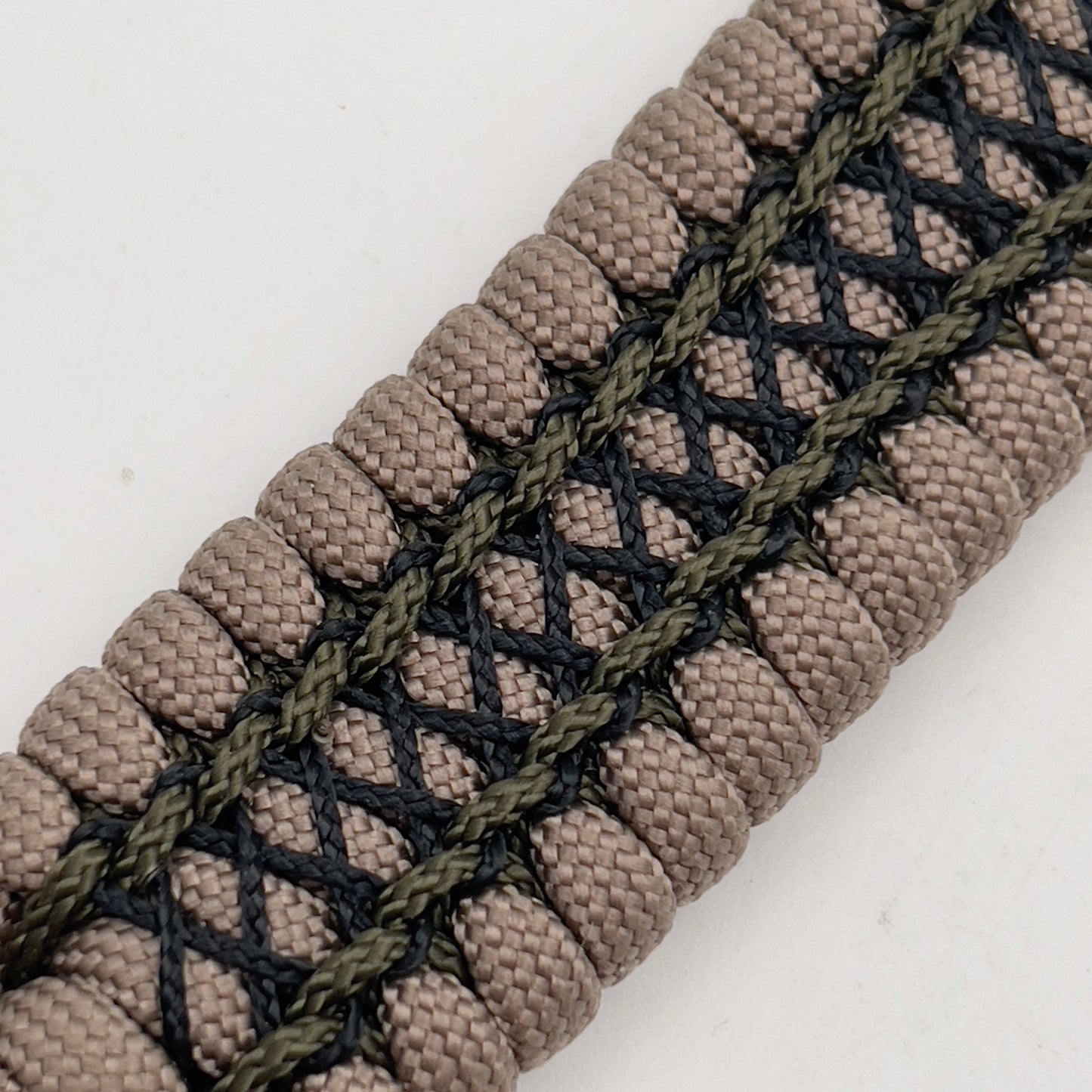Thick, wide, rigid and comfortable braided United States Marine Corps bracelet featuring a 24K gold plated USMC Eagle Globe and Anchor medallion, a gold Cobra style tactical buckle and woven with tan 550 paracord, olive drab micro and black nano cord.