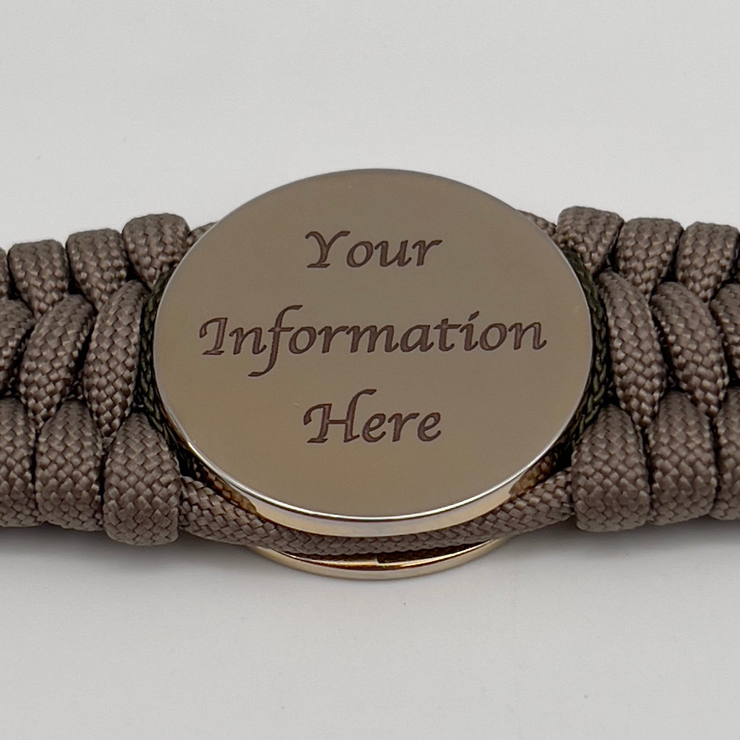 Thick, wide, rigid and comfortable braided United States Marine Corps bracelet featuring a 24K gold plated USMC Eagle Globe and Anchor medallion, a gold Cobra style tactical buckle and woven with tan 550 paracord, olive drab micro and black nano cord.