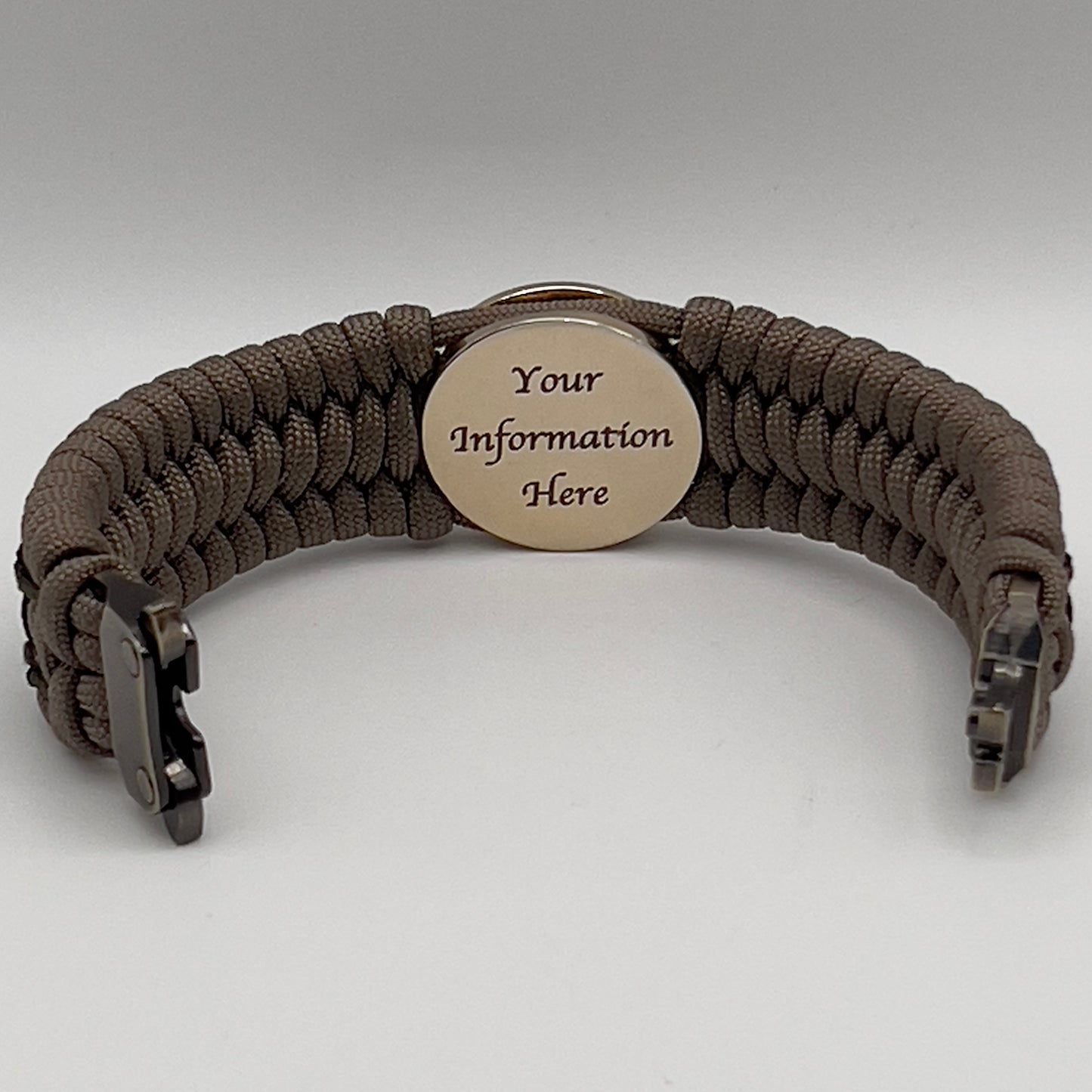 Thick, wide, rigid and comfortable braided United States Marine Corps bracelet featuring a 24K gold plated USMC Eagle Globe and Anchor medallion, a gold Cobra style tactical buckle and woven with tan 550 paracord, olive drab micro and black nano cord.