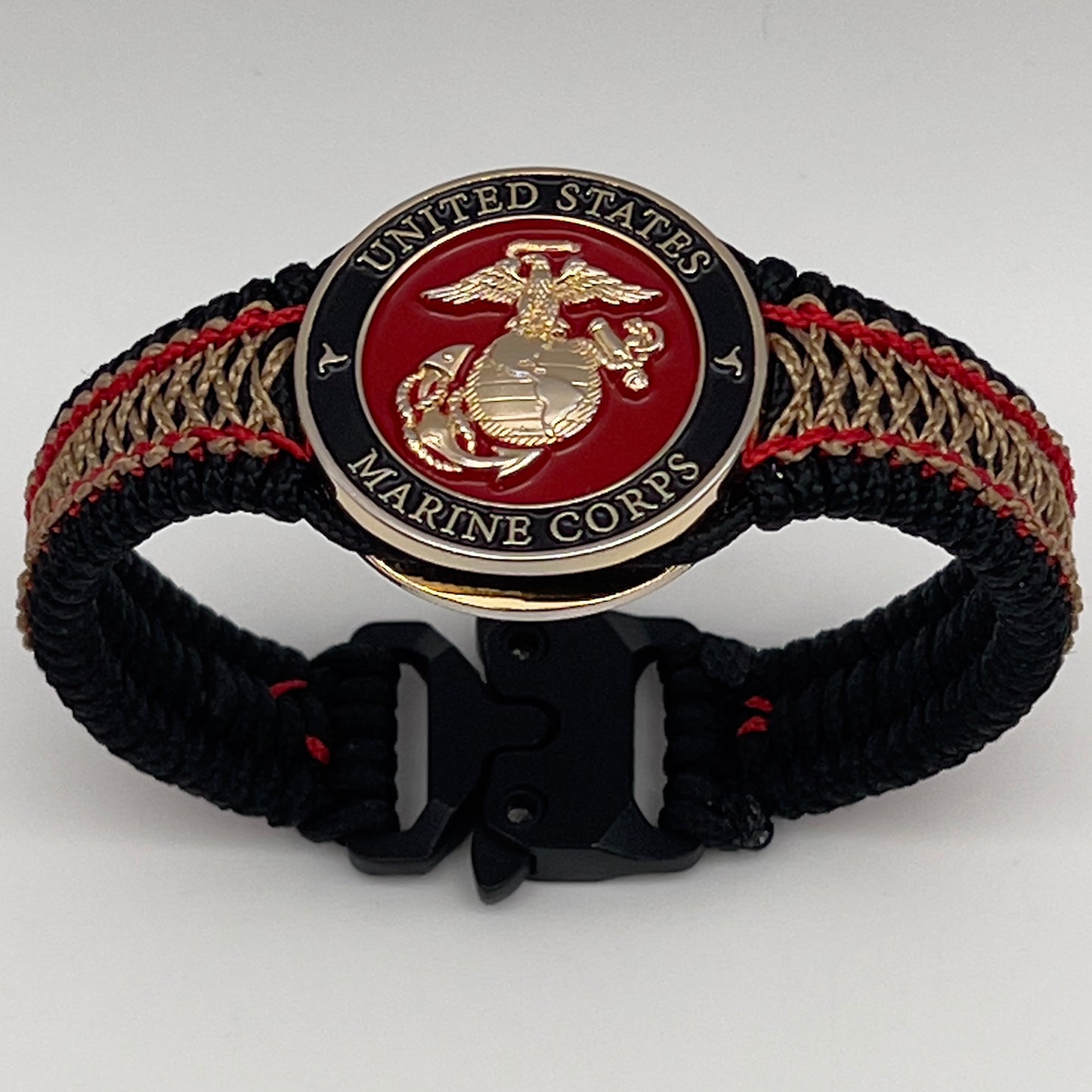 Thin, narrow, flexible and comfortable braided United States Marine Corps bracelet featuring a 24K gold plated USMC Eagle Globe and Anchor medallion, a black Cobra style tactical buckle and woven with black Type-1 paracord and Imperial Red and Gold nano cord.