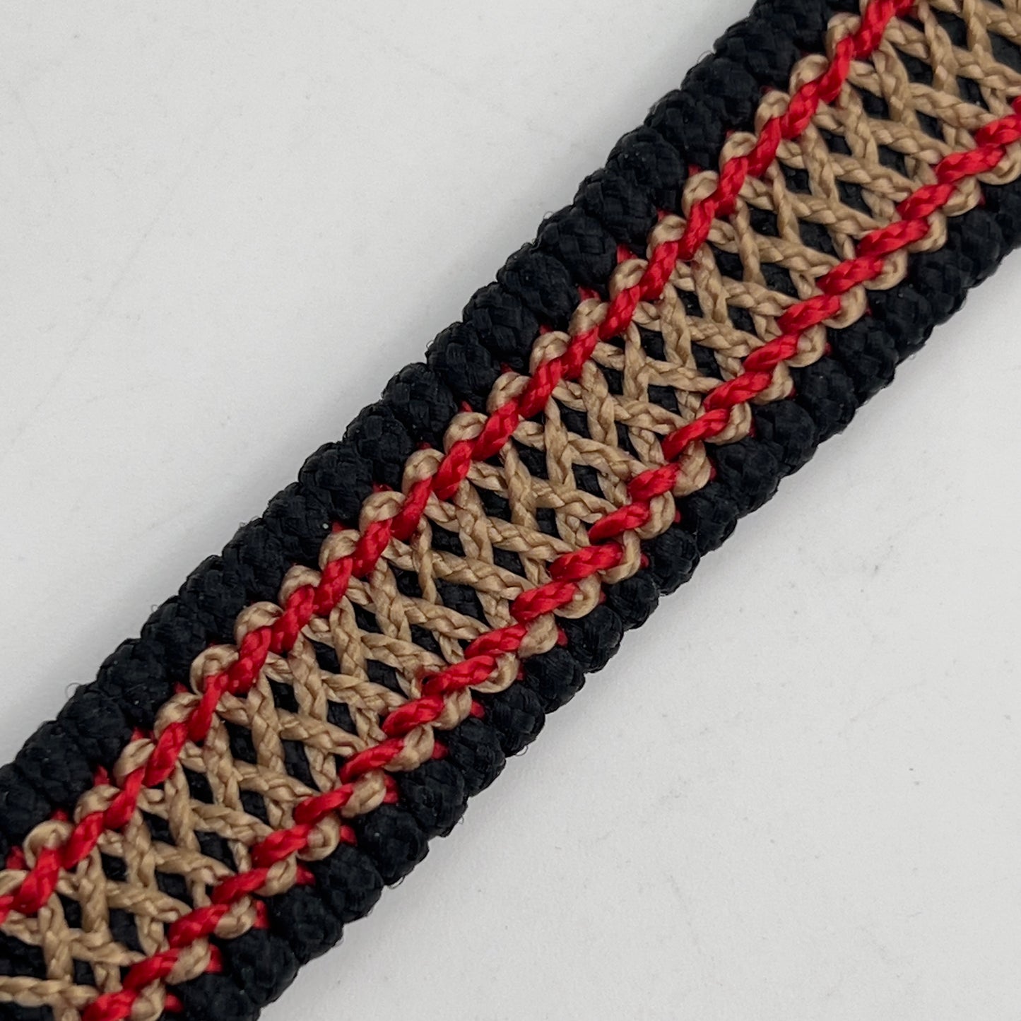 Thin, narrow, flexible and comfortable braided United States Marine Corps bracelet featuring a 24K gold plated USMC Eagle Globe and Anchor medallion, a black Cobra style tactical buckle and woven with black Type-1 paracord and Imperial Red and Gold nano cord.