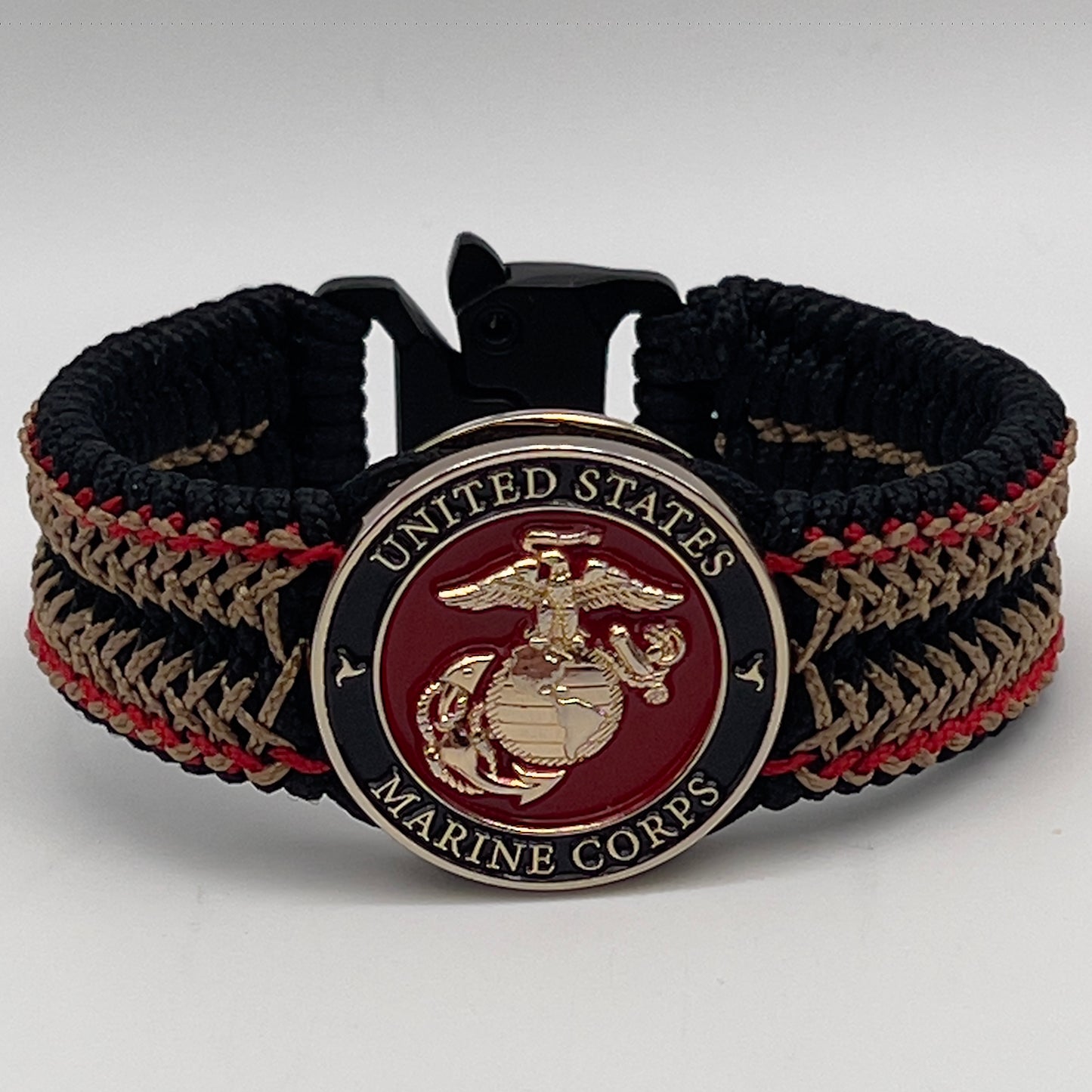 Thin, narrow, flexible and comfortable braided United States Marine Corps bracelet featuring a 24K gold plated USMC Eagle Globe and Anchor medallion, a black Cobra style tactical buckle and woven with black Type-1 paracord and Imperial Red and Gold nano cord.