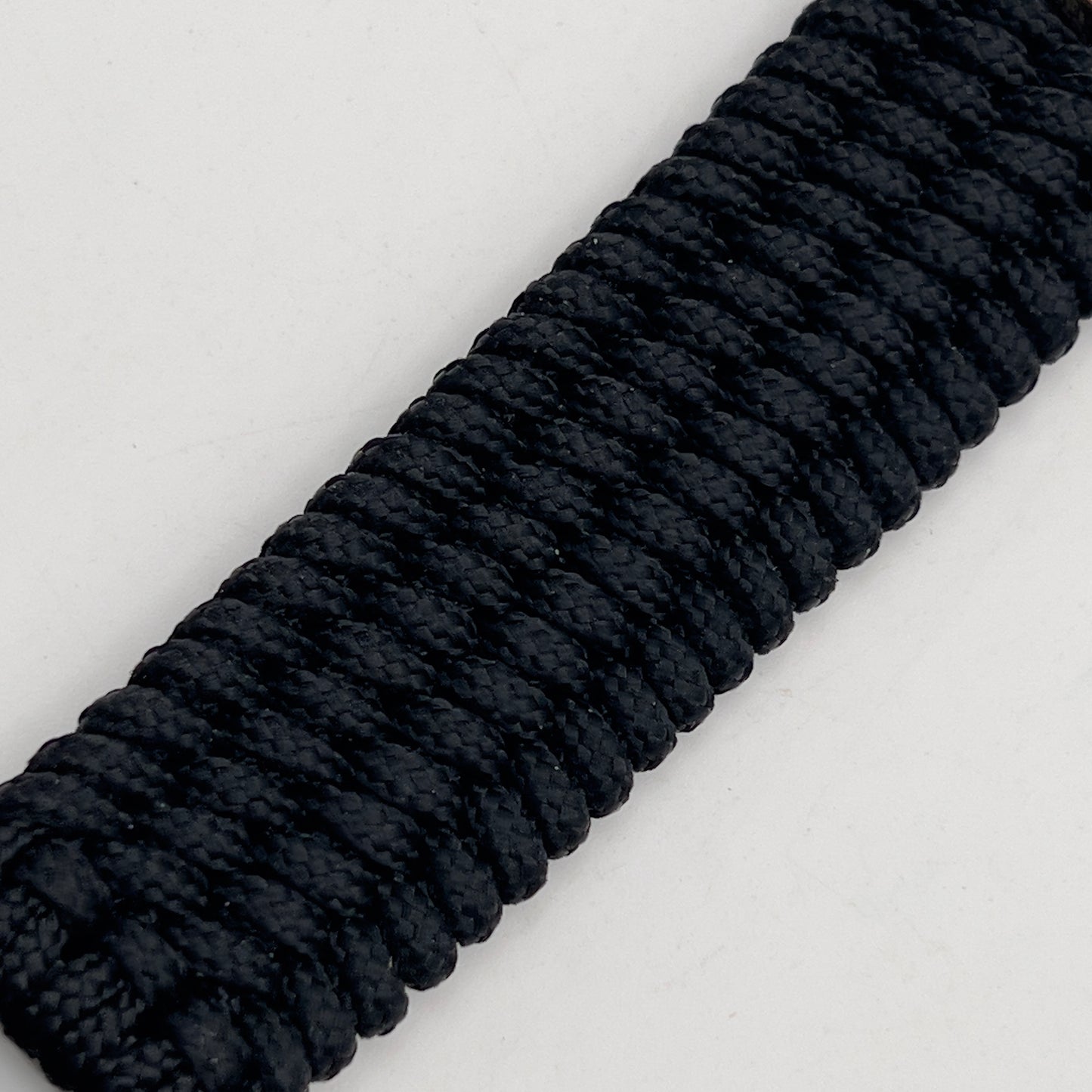 Thin, medium width, flexible and comfortable braided United States Marine Corps bracelet featuring a 24K gold plated USMC officer Eagle Globe and Anchor medallion, a black Cobra style tactical buckle and woven with black Type-1 paracord.