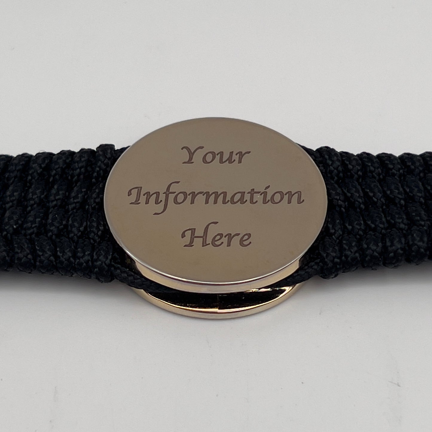 Thin, medium width, flexible and comfortable braided United States Marine Corps bracelet featuring a 24K gold plated USMC officer Eagle Globe and Anchor medallion, a black Cobra style tactical buckle and woven with black Type-1 paracord.
