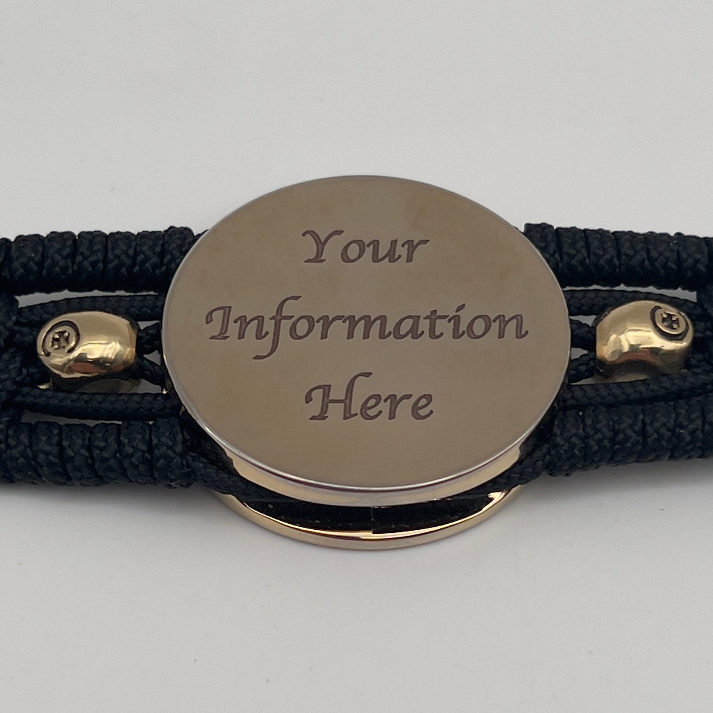 Thin, medium width, flexible and comfortable braided United States Marine Corps bracelet featuring a 24K gold plated USMC officer Eagle Globe and Anchor medallion, two gold plated skulls, a black Cobra style tactical buckle and woven with black Type-1 paracord.