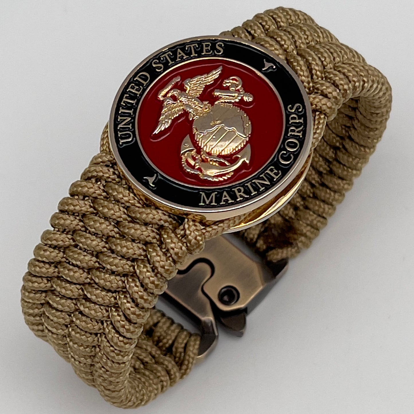 Thin, medium width, flexible and comfortable braided United States Marine Corps bracelet featuring a 24K gold plated USMC officer Eagle Globe and Anchor medallion, a gold Cobra style tactical buckle and woven with gold Type-1 paracord.