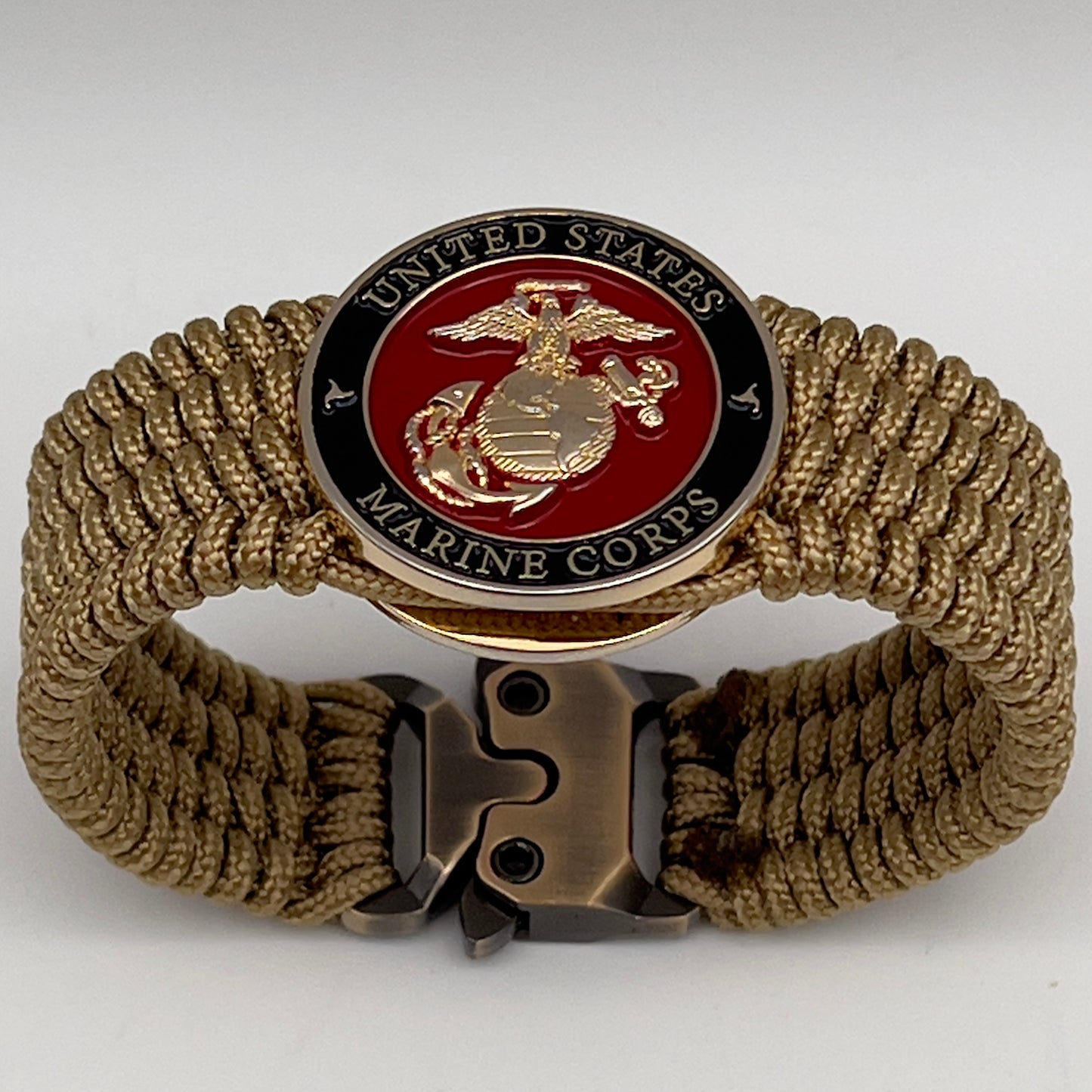 Thin, medium width, flexible and comfortable braided United States Marine Corps bracelet featuring a 24K gold plated USMC officer Eagle Globe and Anchor medallion, a gold Cobra style tactical buckle and woven with gold Type-1 paracord.