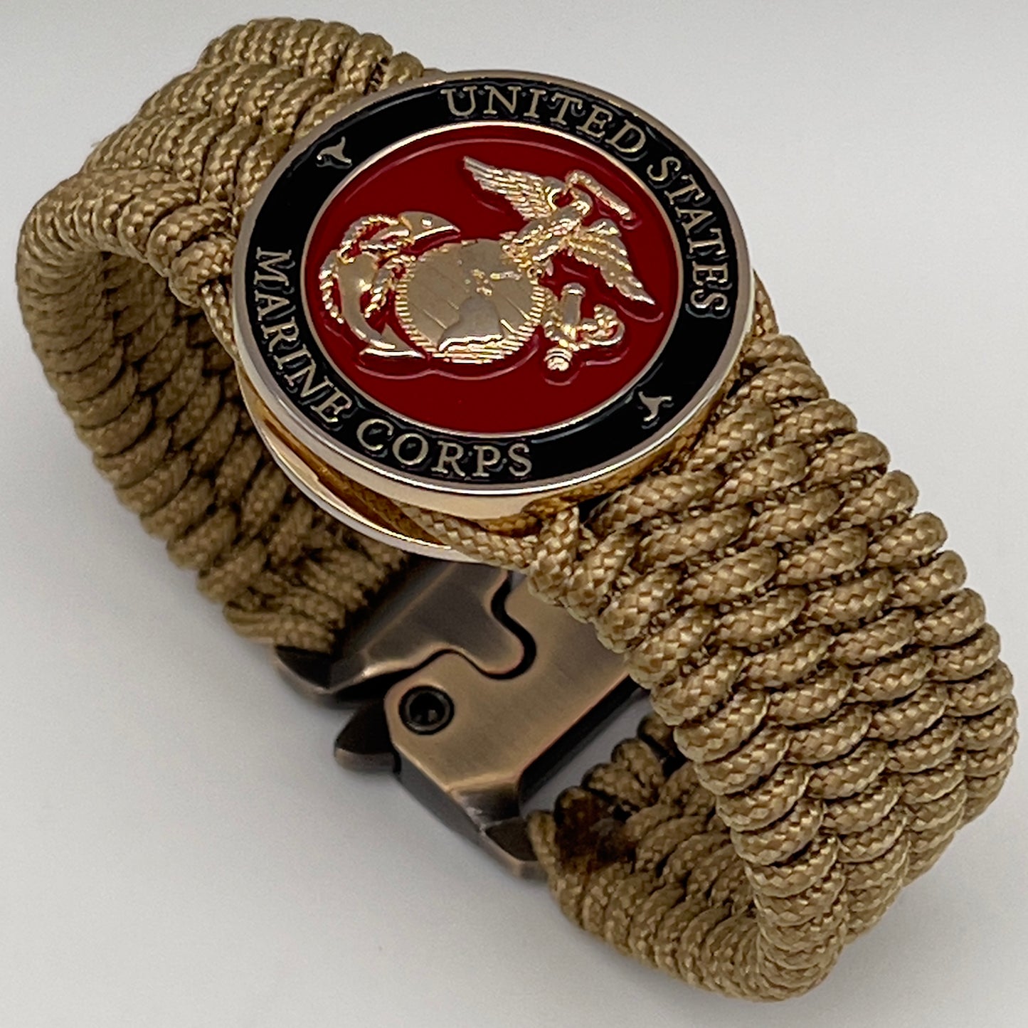 Thin, medium width, flexible and comfortable braided United States Marine Corps bracelet featuring a 24K gold plated USMC officer Eagle Globe and Anchor medallion, a gold Cobra style tactical buckle and woven with gold Type-1 paracord.