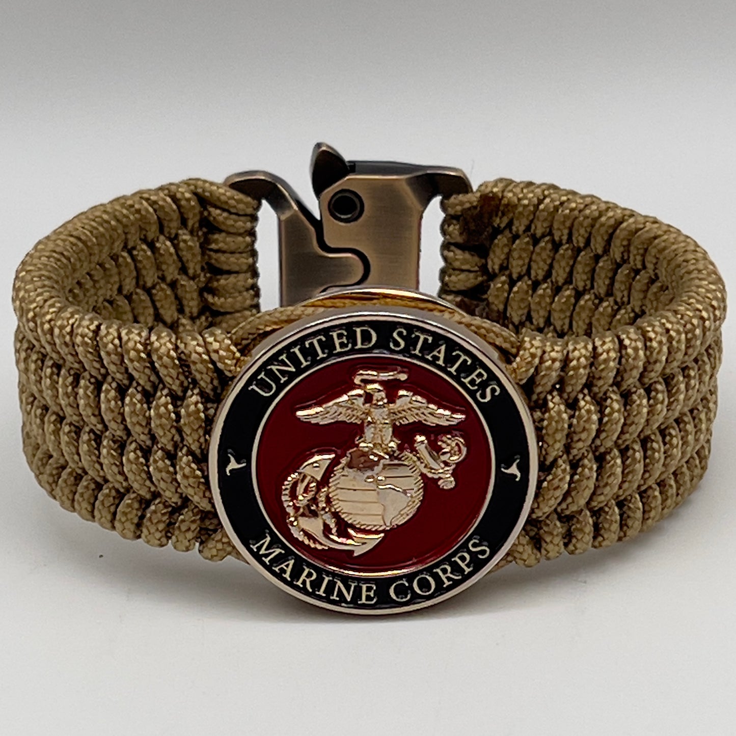 Thin, medium width, flexible and comfortable braided United States Marine Corps bracelet featuring a 24K gold plated USMC officer Eagle Globe and Anchor medallion, a gold Cobra style tactical buckle and woven with gold Type-1 paracord.