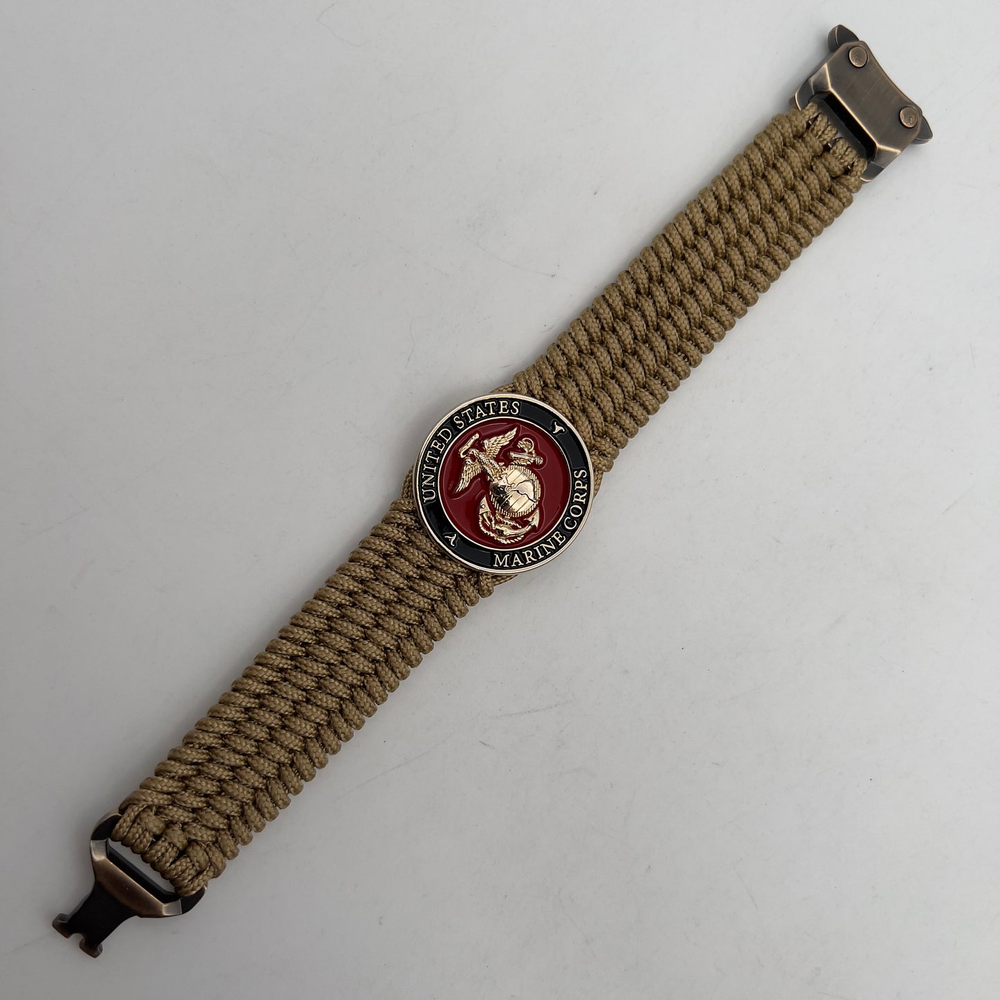 Thin, medium width, flexible and comfortable braided United States Marine Corps bracelet featuring a 24K gold plated USMC officer Eagle Globe and Anchor medallion, a gold Cobra style tactical buckle and woven with gold Type-1 paracord.