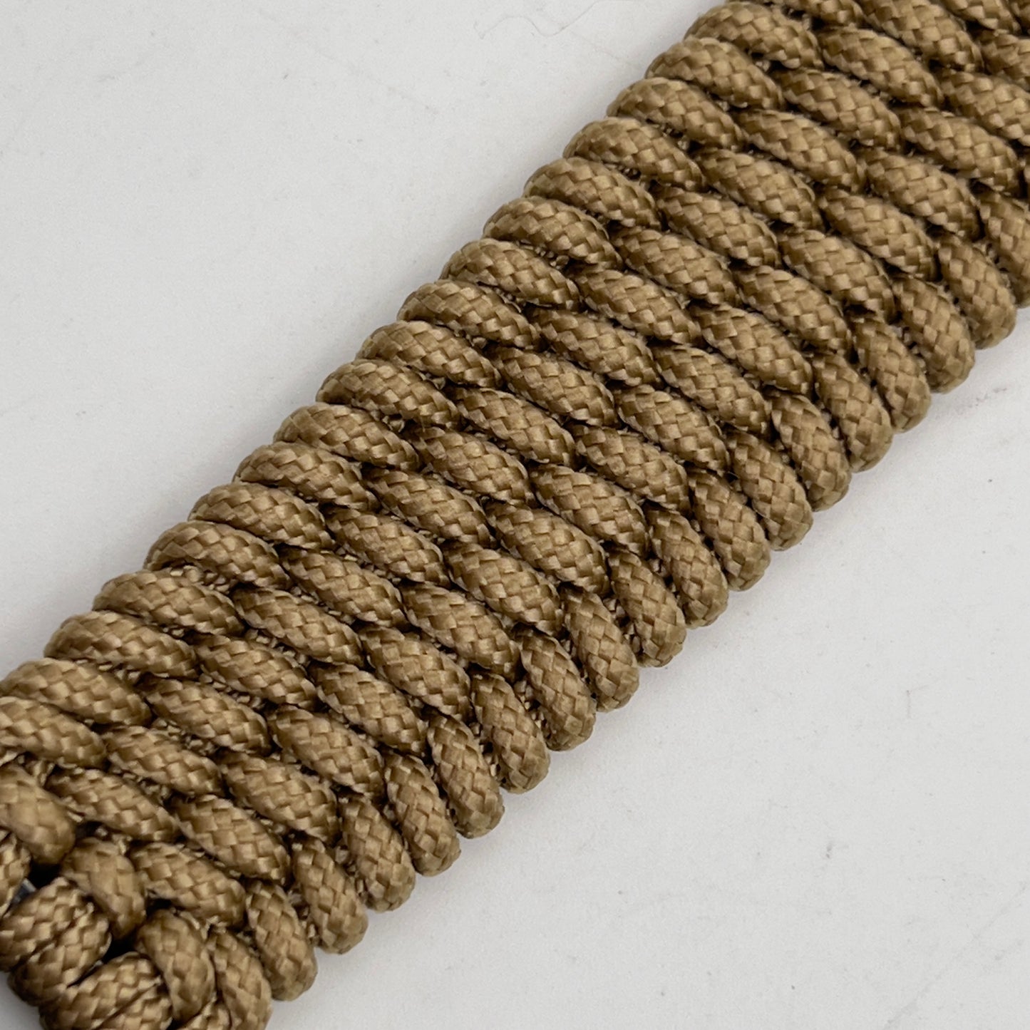 Thin, medium width, flexible and comfortable braided United States Marine Corps bracelet featuring a 24K gold plated USMC officer Eagle Globe and Anchor medallion, a gold Cobra style tactical buckle and woven with gold Type-1 paracord.