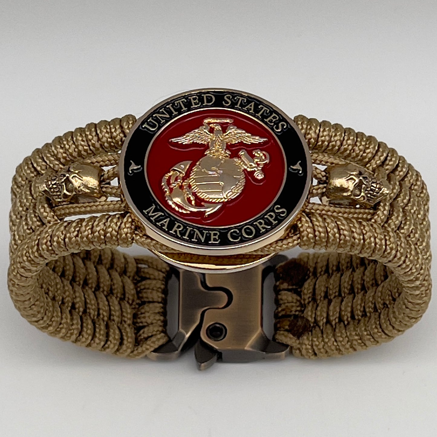 Thin, medium width, flexible and comfortable braided United States Marine Corps bracelet featuring a 24K gold plated USMC officer Eagle Globe and Anchor medallion, two gold plated skulls, a gold Cobra style tactical buckle and woven with gold Type-1 paracord.