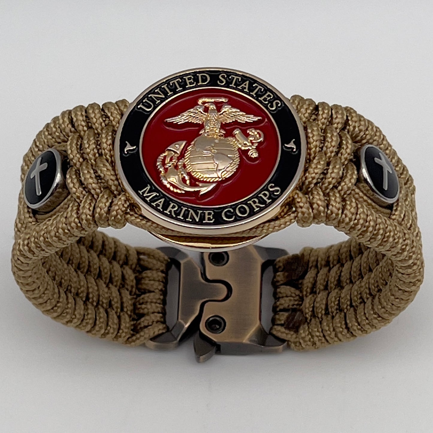 Thin, medium width, flexible and comfortable braided United States Marine Corps bracelet featuring a 24K gold plated USMC officer Eagle Globe and Anchor medallion, two Christian crosses, a gold Cobra style tactical buckle and woven with gold Type-1 paracord.