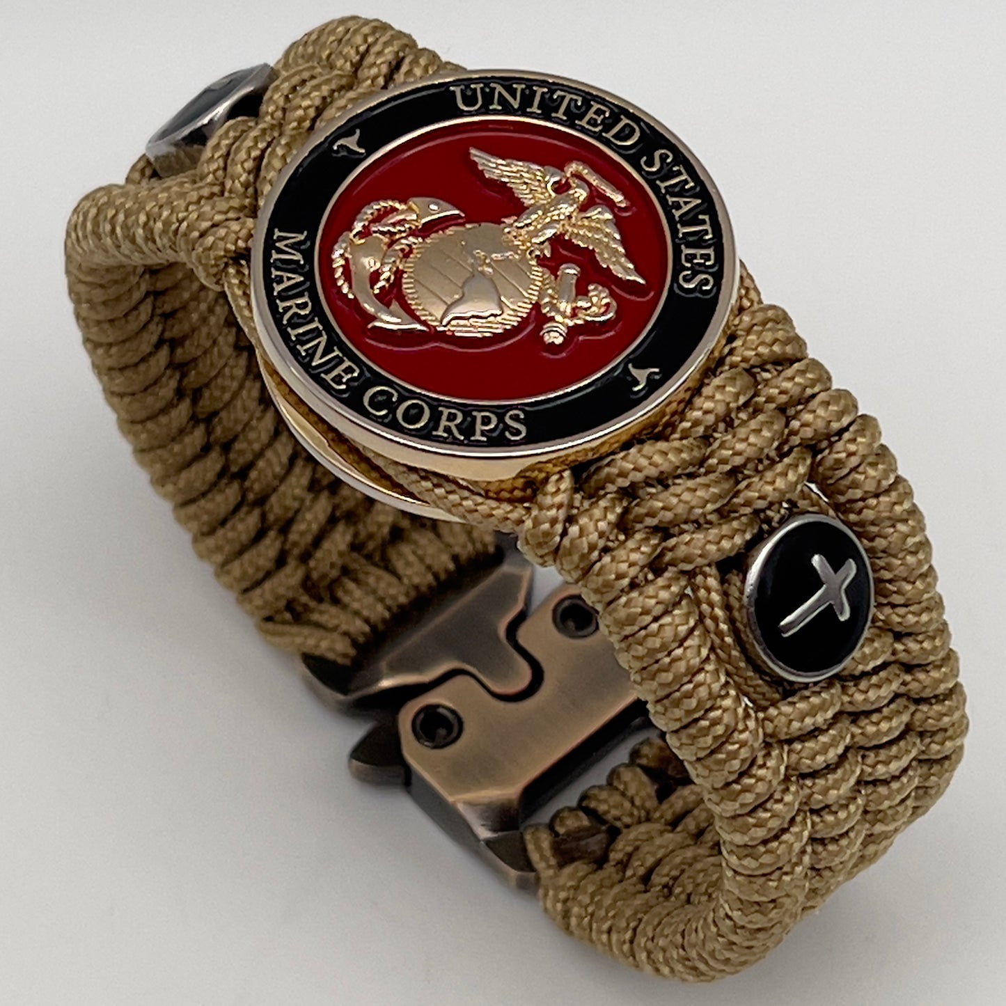 Thin, medium width, flexible and comfortable braided United States Marine Corps bracelet featuring a 24K gold plated USMC officer Eagle Globe and Anchor medallion, two Christian crosses, a gold Cobra style tactical buckle and woven with gold Type-1 paracord.
