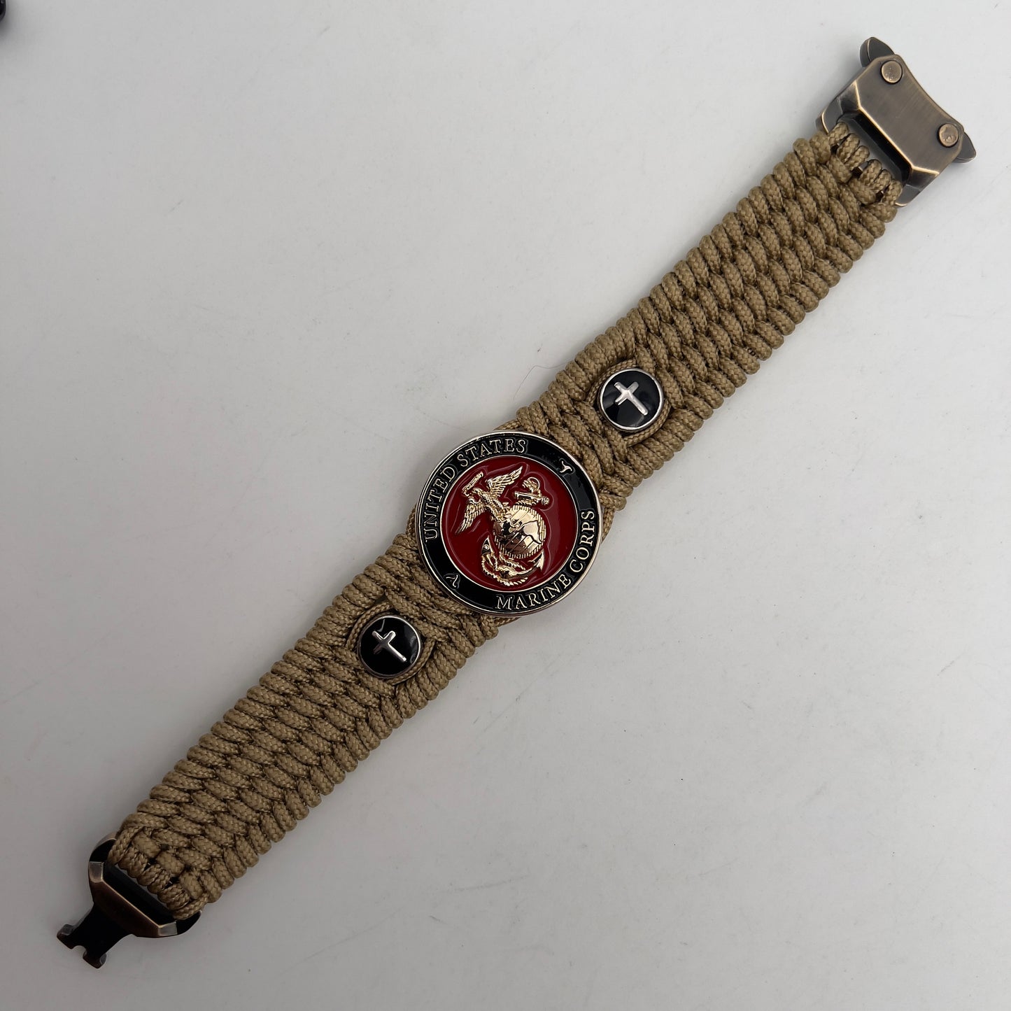 Thin, medium width, flexible and comfortable braided United States Marine Corps bracelet featuring a 24K gold plated USMC officer Eagle Globe and Anchor medallion, two Christian crosses, a gold Cobra style tactical buckle and woven with gold Type-1 paracord.